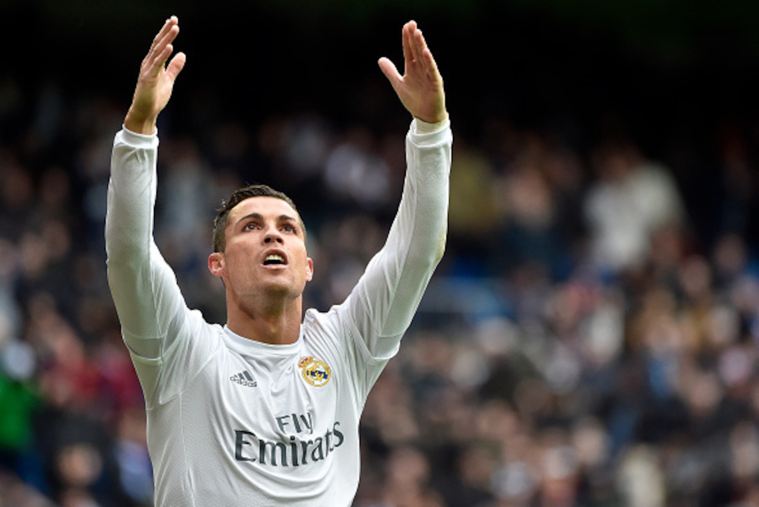 Real Madrid's Portuguese forward Cristiano Ronaldo celebrates after making it a hat trick by scoring his third goal during the Spanish league football match Real Madrid CF vs RC Celta de Vigo at the Santiago Bernabeu stadium in Madrid on March 5, 2016. / 