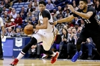 Jan 19, 2016; New Orleans, LA, USA; New Orleans Pelicans forward Anthony Davis (23) drives past Minnesota Timberwolves center Karl-Anthony Towns (32) during the second half of a game at the Smoothie King Center. The Pelicans defeated the Timberwolves 114-