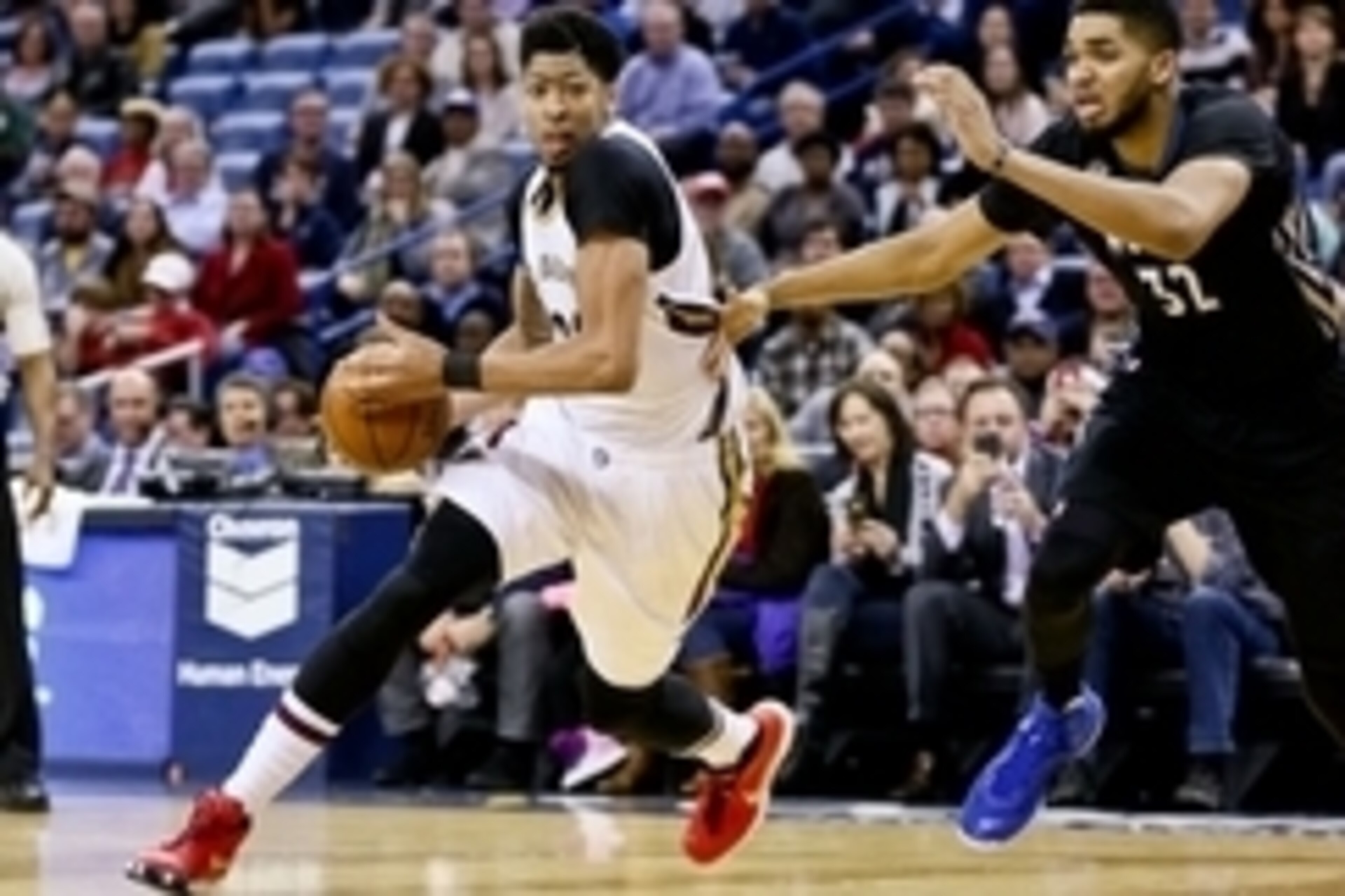 Jan 19, 2016; New Orleans, LA, USA; New Orleans Pelicans forward Anthony Davis (23) drives past Minnesota Timberwolves center Karl-Anthony Towns (32) during the second half of a game at the Smoothie King Center. The Pelicans defeated the Timberwolves 114-