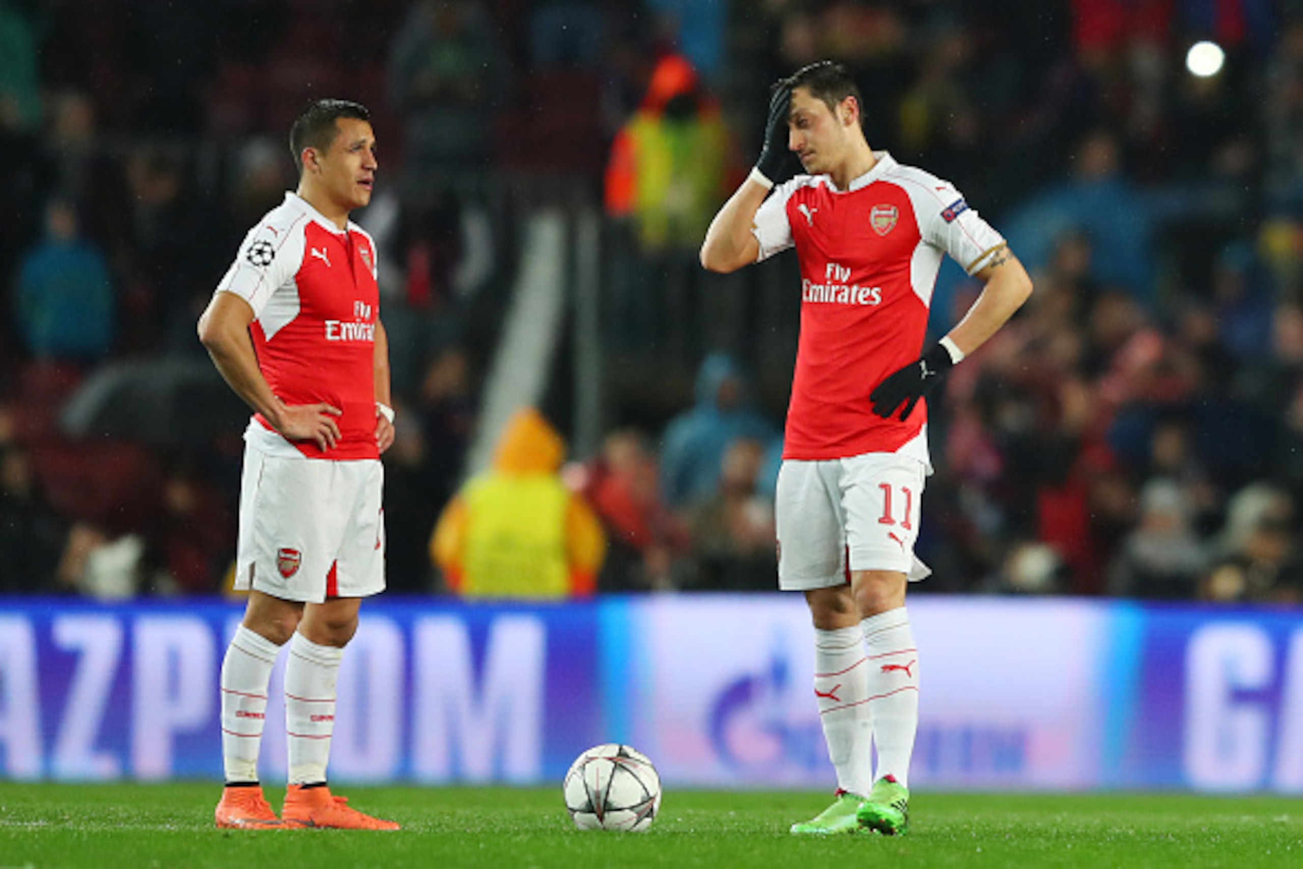 BARCELONA, SPAIN - MARCH 16: Alexis Sanchez (L) and Mesut Ozil (R) of Arsenal show their dejection after Barcelona's first goal during the UEFA Champions League round of 16, second Leg match between FC Barcelona and Arsenal FC at Camp Nou on March 16, 201