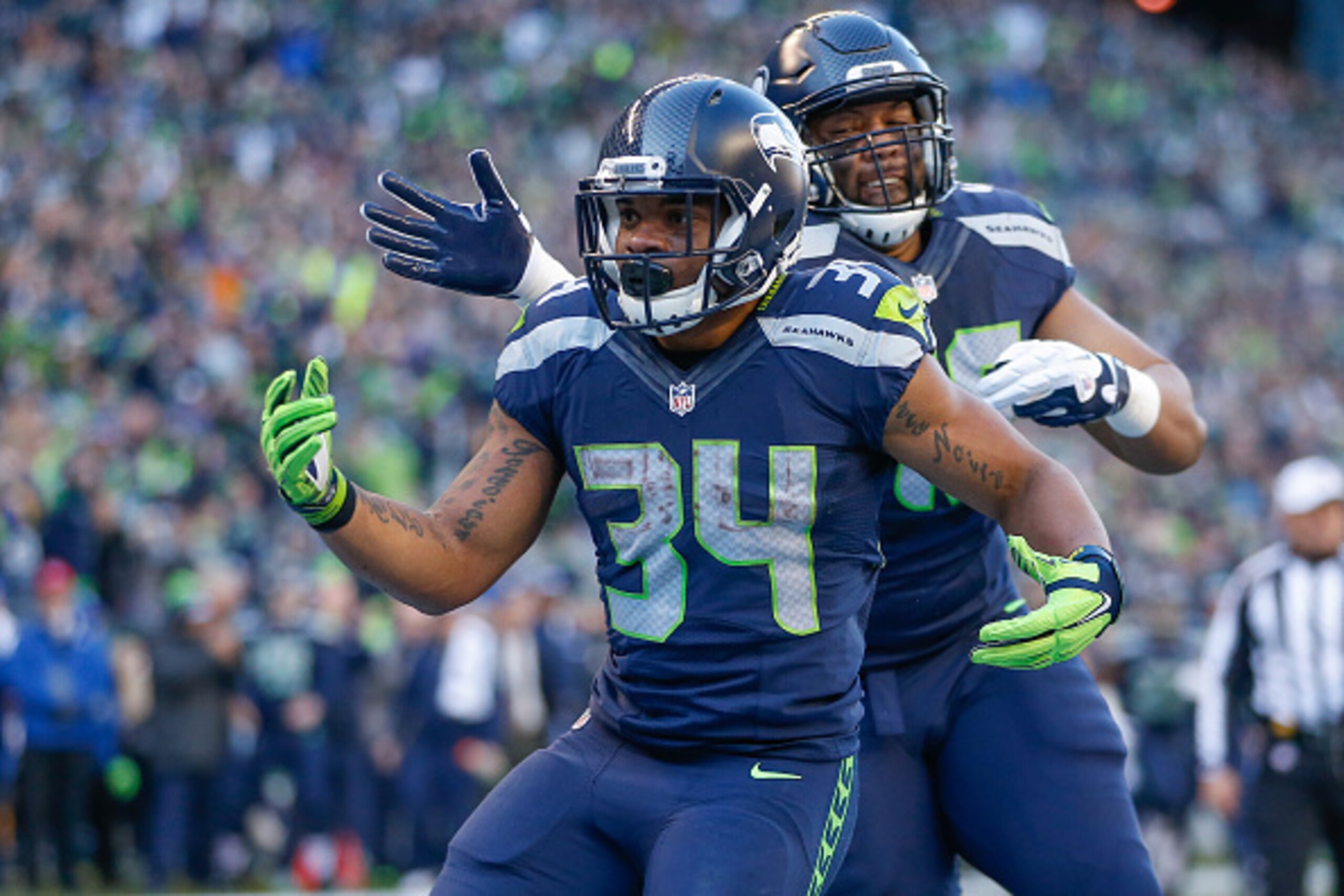 SEATTLE, WA - NOVEMBER 22:  Running back Thomas Rawls #34 of the Seattle Seahawks is congratulated by fullback Will Tukuafu #46 after scoring a touchdown in the first quarter against the San Francisco 49ers at CenturyLink Field on November 22, 2015 in Sea