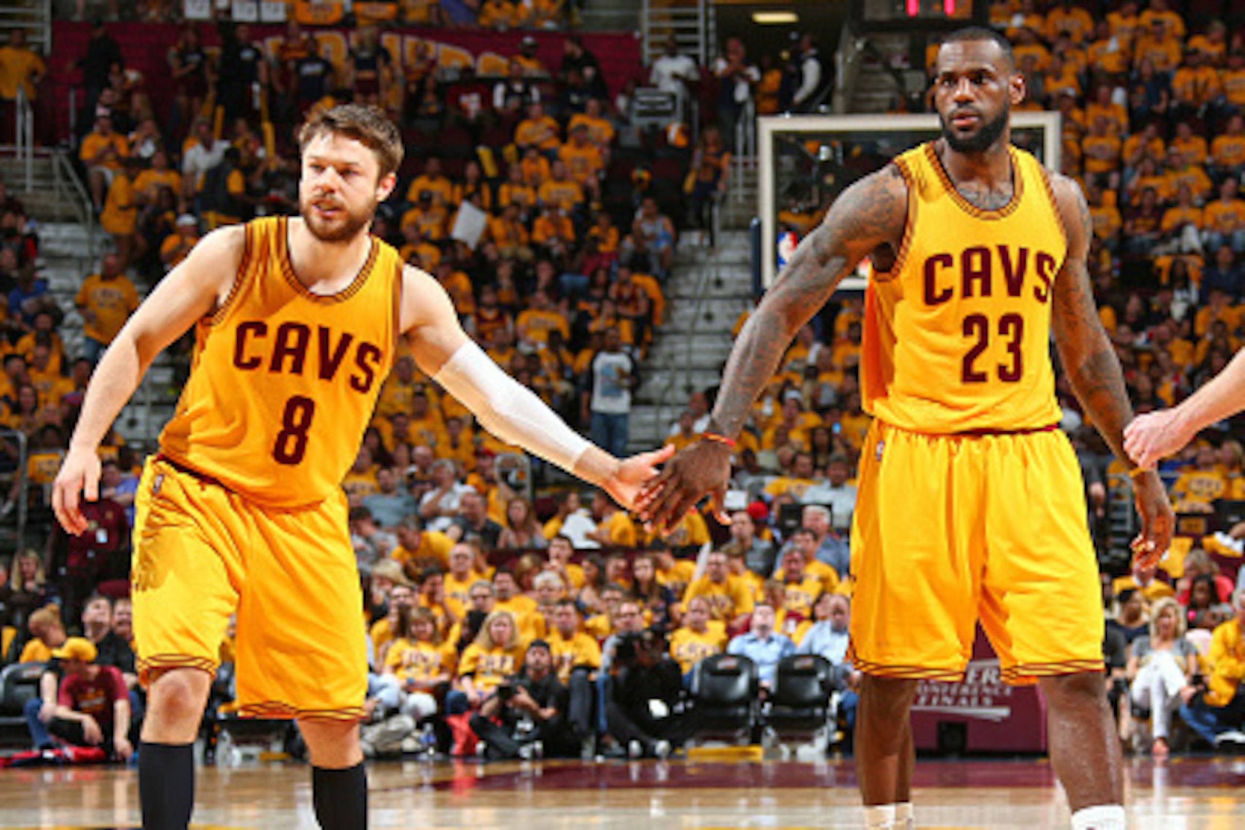 CLEVELAND, OH - MAY 24:  LeBron James #23 shakes hands with Matthew Dellavedova #8 of the Cleveland Cavaliers in Game Three of the Eastern Conference Finals against the Atlanta Hawks during the 2015 NBA Playoffs on May 24, 2015 at Quicken Loans Arena in C