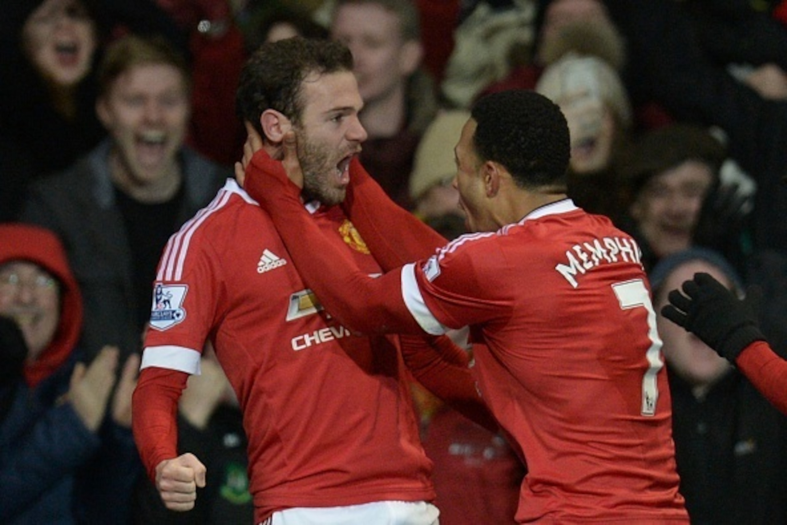 Manchester United's Spanish midfielder Juan Mata (L) celebrates scoring the opening goal with Manchester United's Dutch midfielder Memphis Depay (R) during the English Premier League football match between Manchester United and Watford at Old Trafford in 