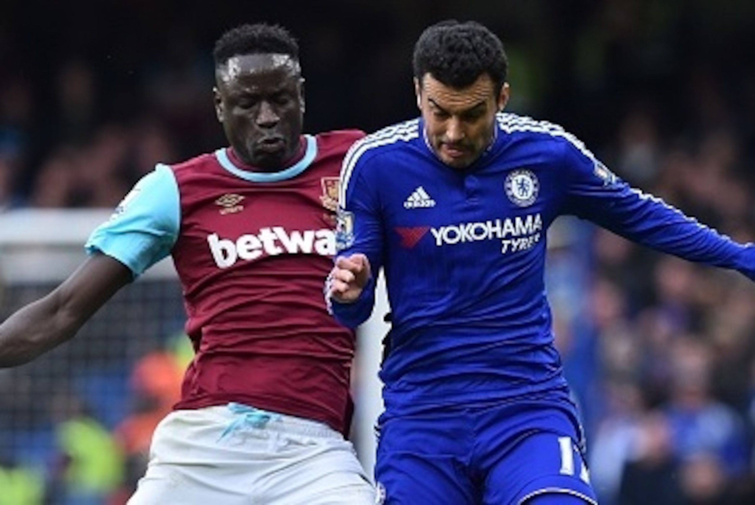 West Ham United's Senegalese midfielder Cheikhou Kouyate is booked for this challenge on Chelsea's Spanish midfielder Pedro (R) during the English Premier League football match between Chelsea and West Ham United at Stamford Bridge in London on March 19, 