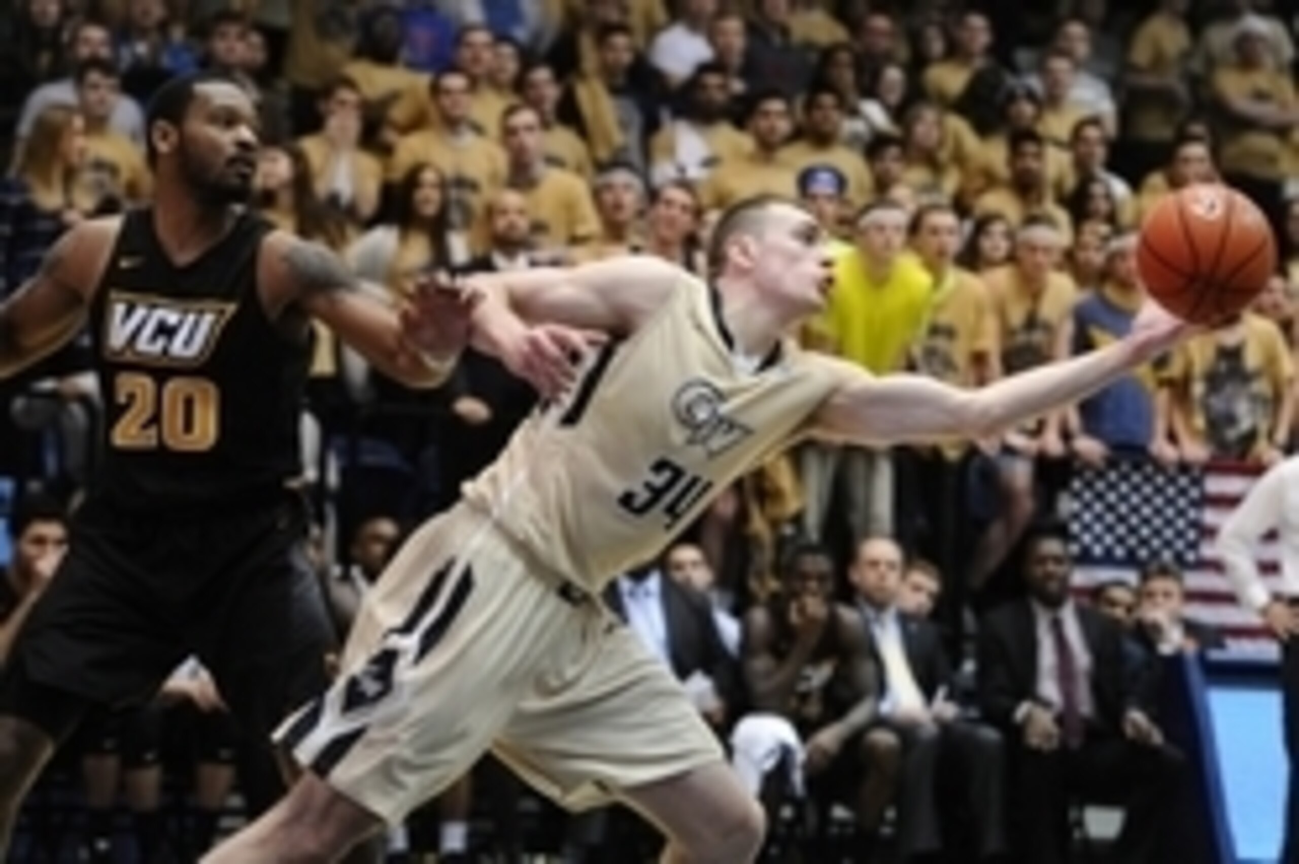 Feb 27, 2016; Washington, DC, USA; George Washington Colonials forward Tyler Cavanaugh (34) reaches for a rebound as Virginia Commonwealth Rams guard Jordan Burgess (20) looks on during the second half at Charles E. Smith Center. Mandatory Credit: Brad Mi