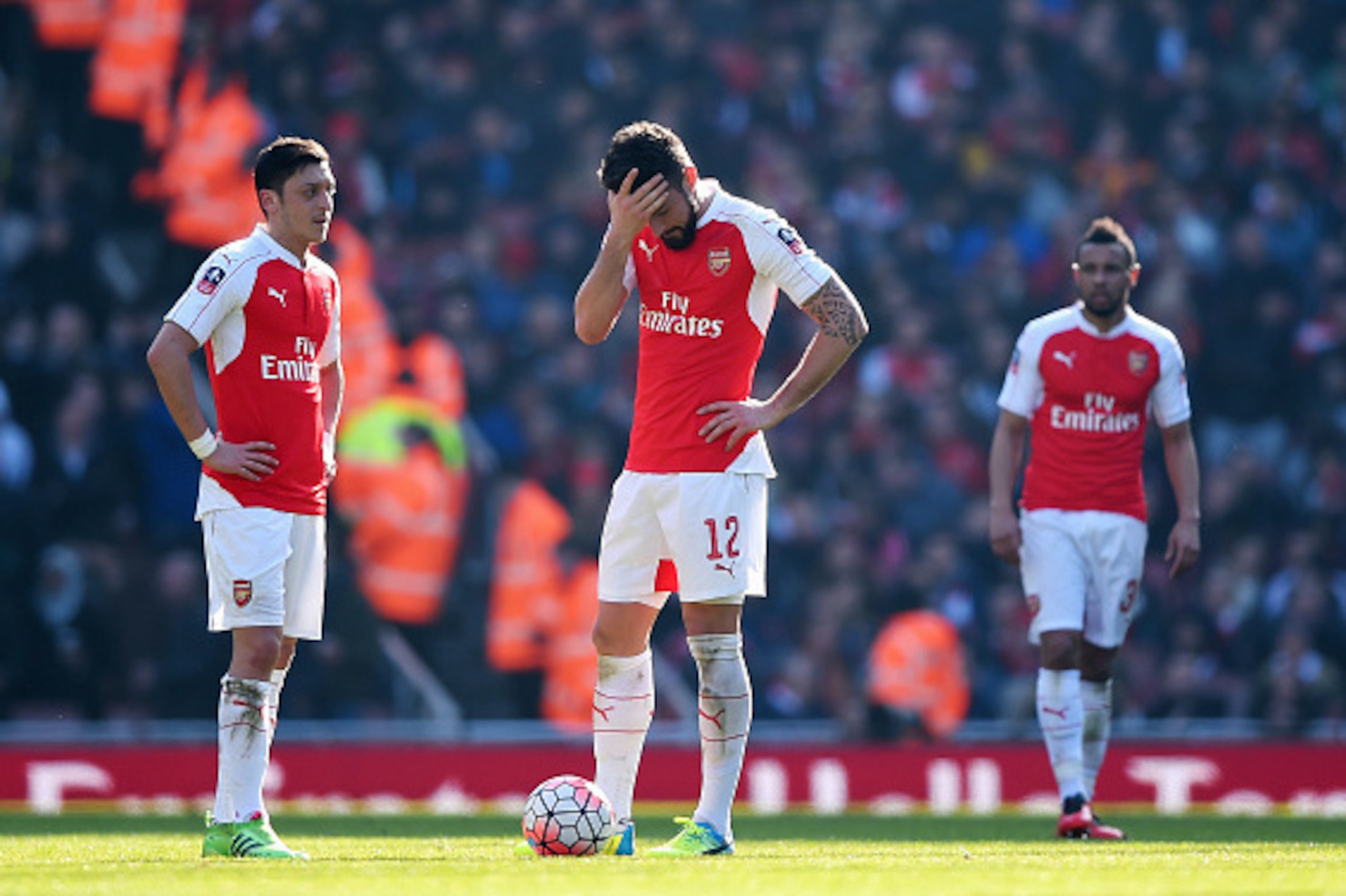 LONDON, ENGLAND - MARCH 13:  Olivier Giroud (12) and Mesut Ozil (11) of Arsenal look dejected as Adlene Guedioura of Watford scores their second goal during the Emirates FA Cup sixth round match between Arsenal and Watford at Emirates Stadium on March 13,