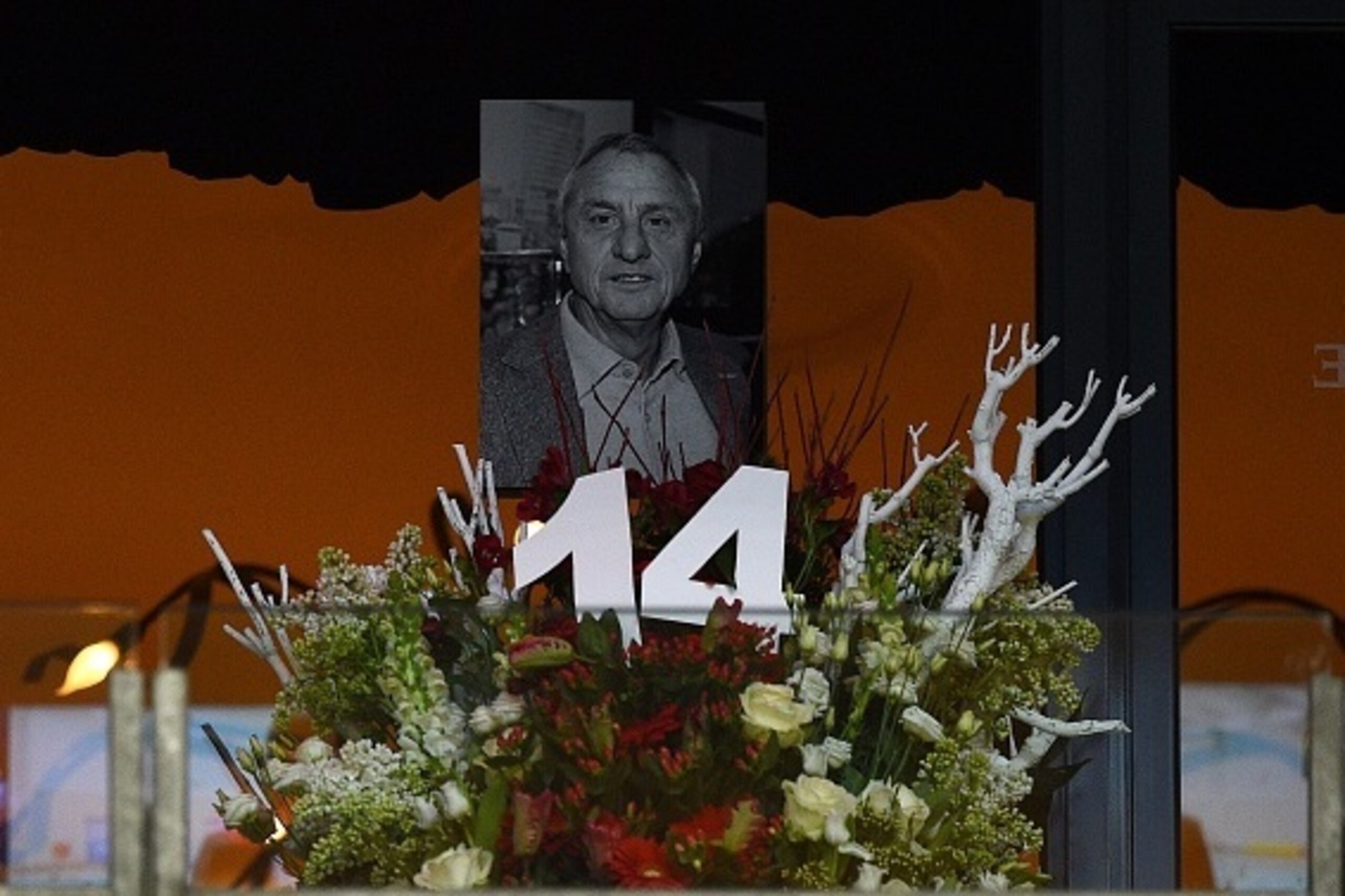 A picture shows a picture on a flower display in memory of late Dutch football legend Johann Cruyff prior to the friendly football match between the Netherlands and France at the Amsterdam ArenA, on March 25, 2016, in Amsterdam. Cruyff passed away on Marc