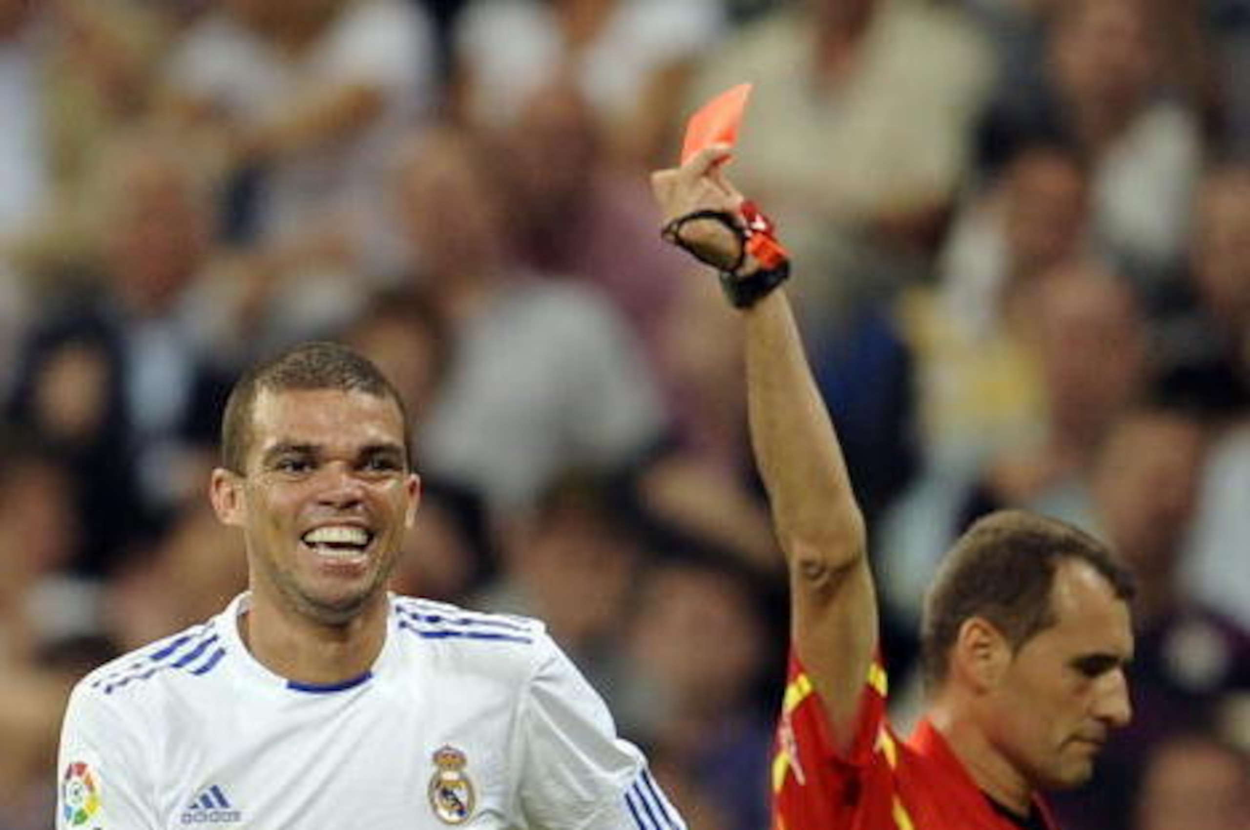 Real Madrid's Portuguese defender Pepe (L) receives a red card from referee Clos Gomez during a Spanish league football match at the Santiago Bernabeu Stadium, on September 21, 2010 in Madrid. AFP PHOTO/Pedro ARMESTRE (Photo credit should read PEDRO ARMES