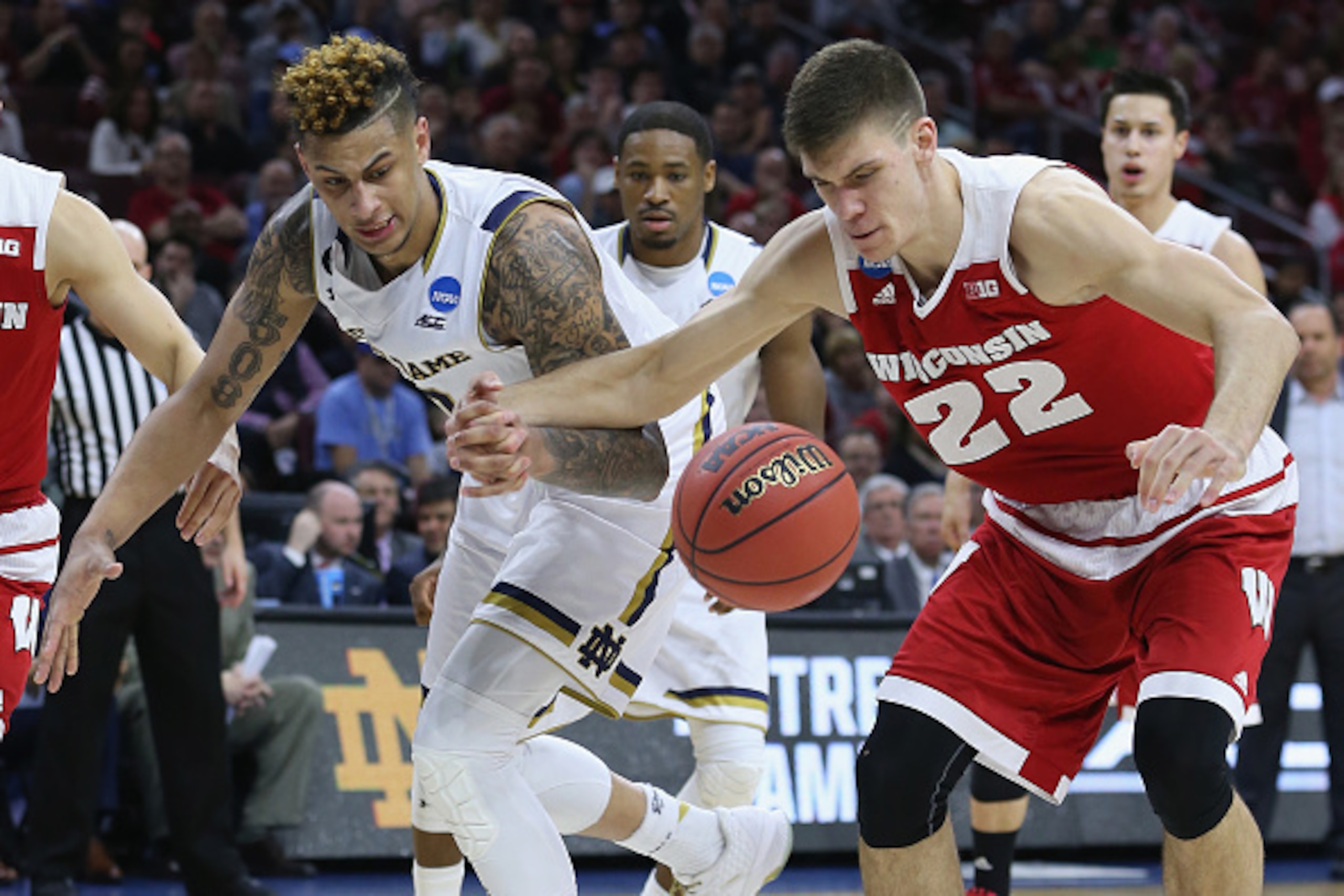 PHILADELPHIA, PA - MARCH 25:  Ethan Happ #22 of the Wisconsin Badgers looks for the ball against Zach Auguste #30 of the Notre Dame Fighting Irish during the 2016 NCAA Men's Basketball Tournament East Regional at Wells Fargo Center on March 25, 2016 in Ph