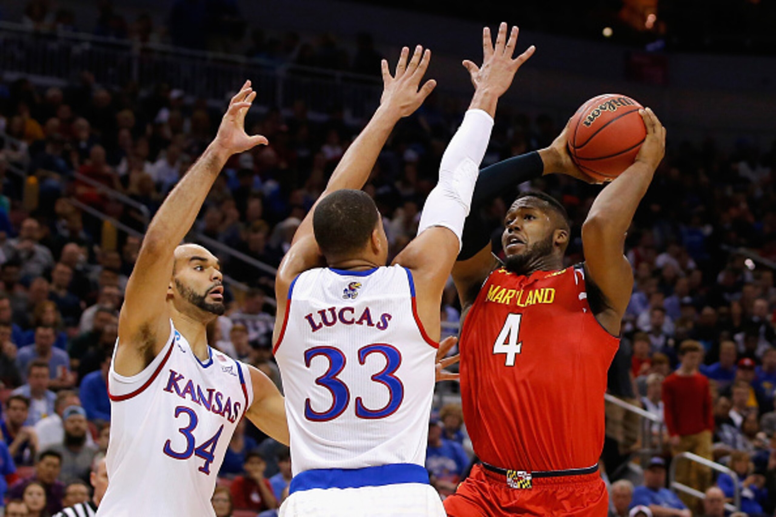 LOUISVILLE, KY - MARCH 24: Robert Carter #4 of the Maryland Terrapins drives to the basket against Landen Lucas #33 of the Kansas Jayhawks and Perry Ellis #34 in the first half during the 2016 NCAA Men's Basketball Tournament South Regional at KFC YUM! C LOUISVILLE, KY - MARCH 24: Robert Carter #4 of the Maryland Terrapins drives to the basket against Landen Lucas #33 of the Kansas Jayhawks and Perry Ellis #34 in the first half during the 2016 NCAA Men's Basketball Tournament South Regional at KFC YUM! C