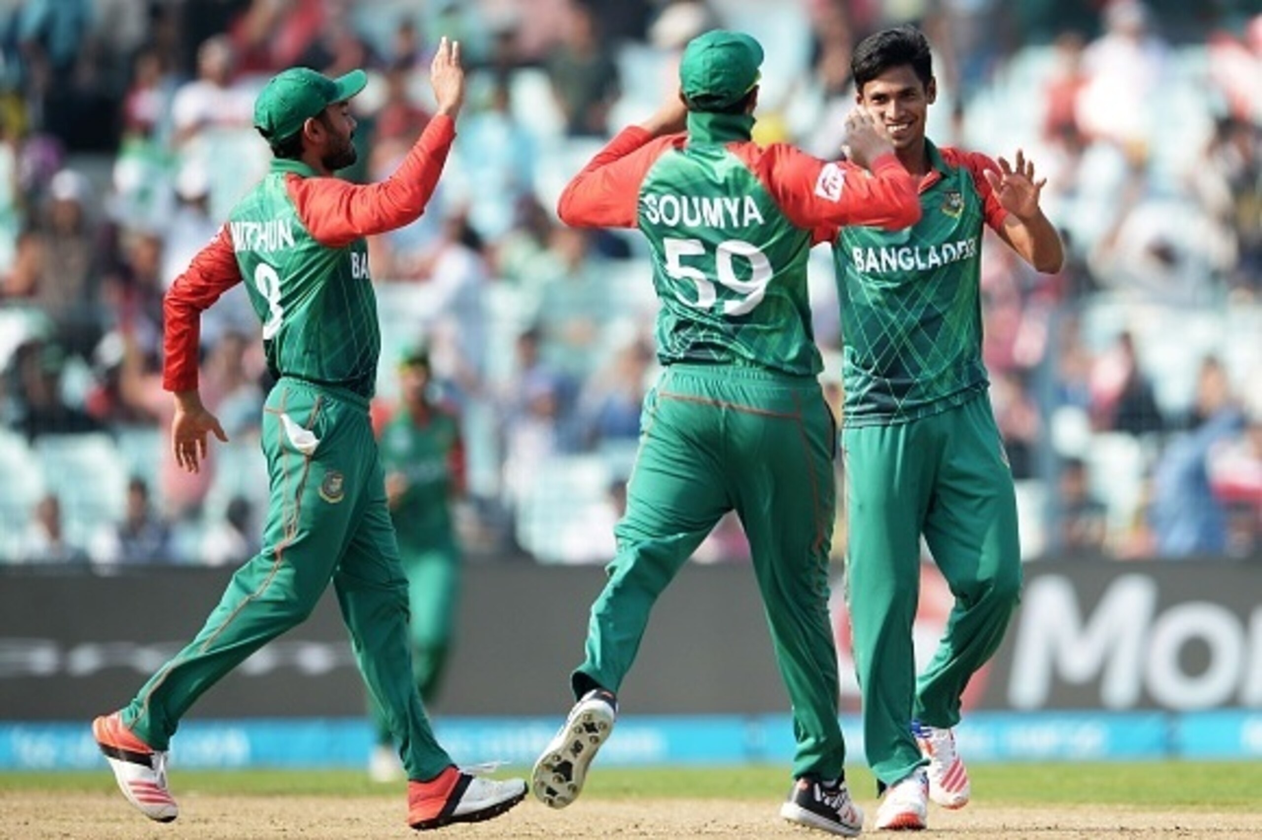 Bangladesh's Mustafizur Rahman(R)celebrates with teammates after the dismissal of New Zealand's Henry Nicholls during the World T20 cricket tournament match between Bangladesh and New Zealand at The Eden Gardens Cricket Stadium in Kolkata on March 26, 201
