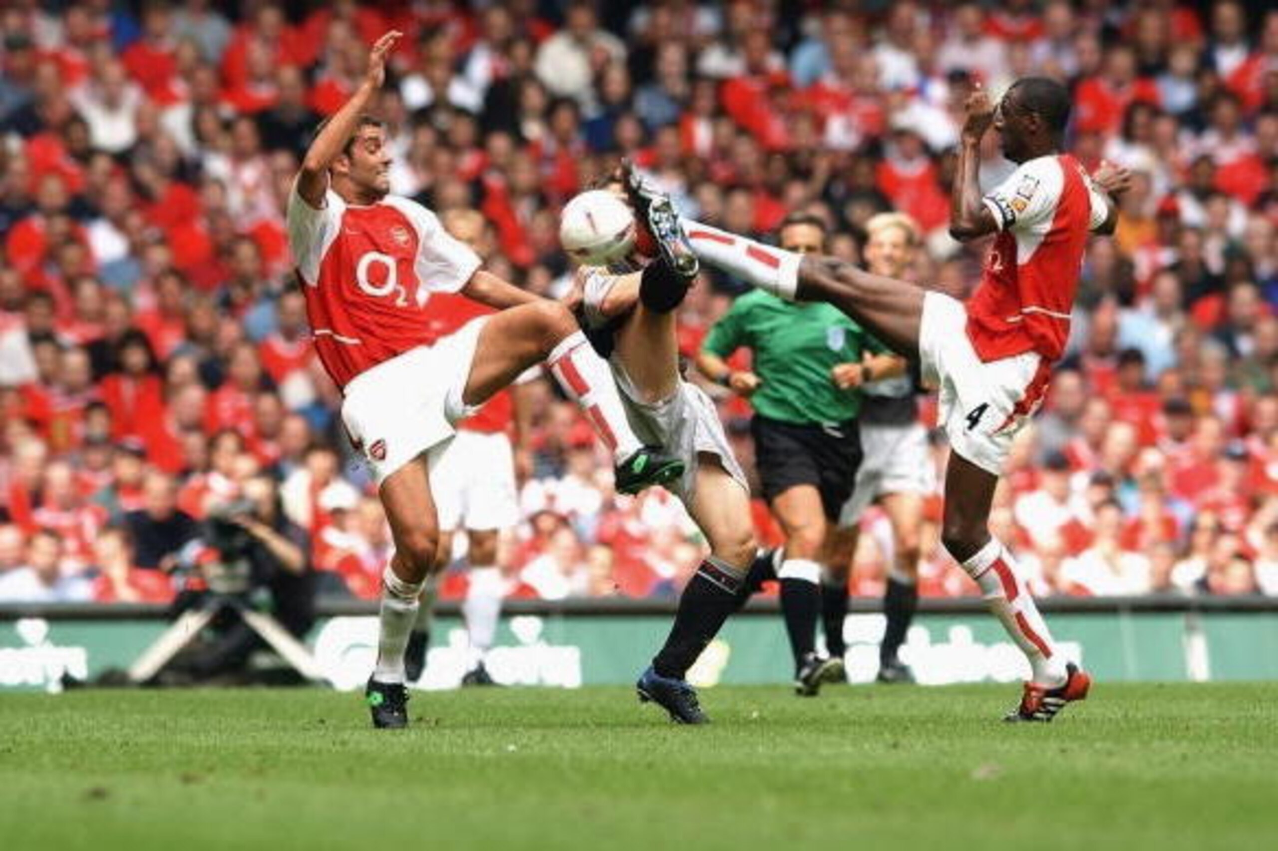 CARDIFF - AUGUST 11:  Michael Owen of Liverpool and Patrick Vieira and Edu of Arsenal challge for the ball  during the FA Community Shield between Arsenal and Liverpool at the Millennium Stadium in Cardiff, Wales on August 11, 2002. (Photo by Shaun Botter