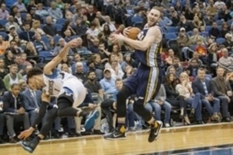 Mar 26, 2016; Minneapolis, MN, USA; Utah Jazz forward Gordon Hayward (20) drives to the basket and gets fouled from Minnesota Timberwolves guard Tyus Jones (1) in the second half at Target Center. the Jazz won 93-84. Mandatory Credit: Jesse Johnson-USA TO