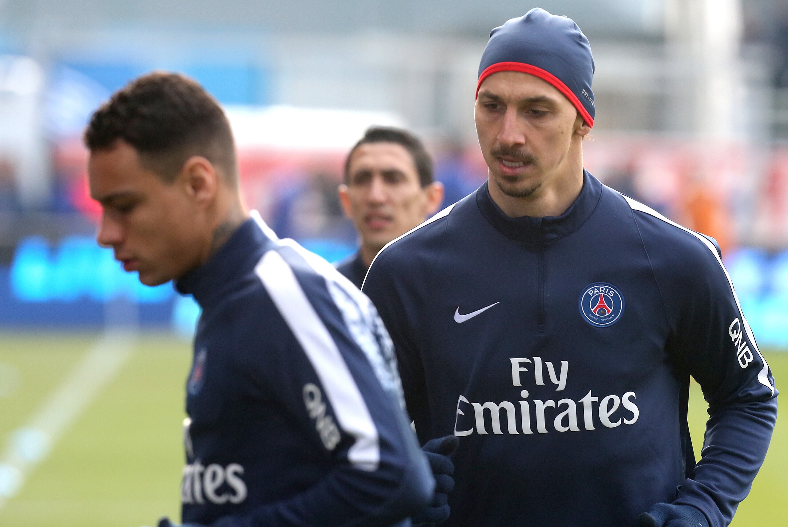 Paris Saint-Germain's Swedish forward Zlatan Ibrahimovic (R) and Paris Saint-Germain's Dutch defender Gregory van der Wiel (L) warm up prior to the French Ligue 1 football match between Troyes and Paris Saint-Germain on March 13, 2016 at the Aube Stadium