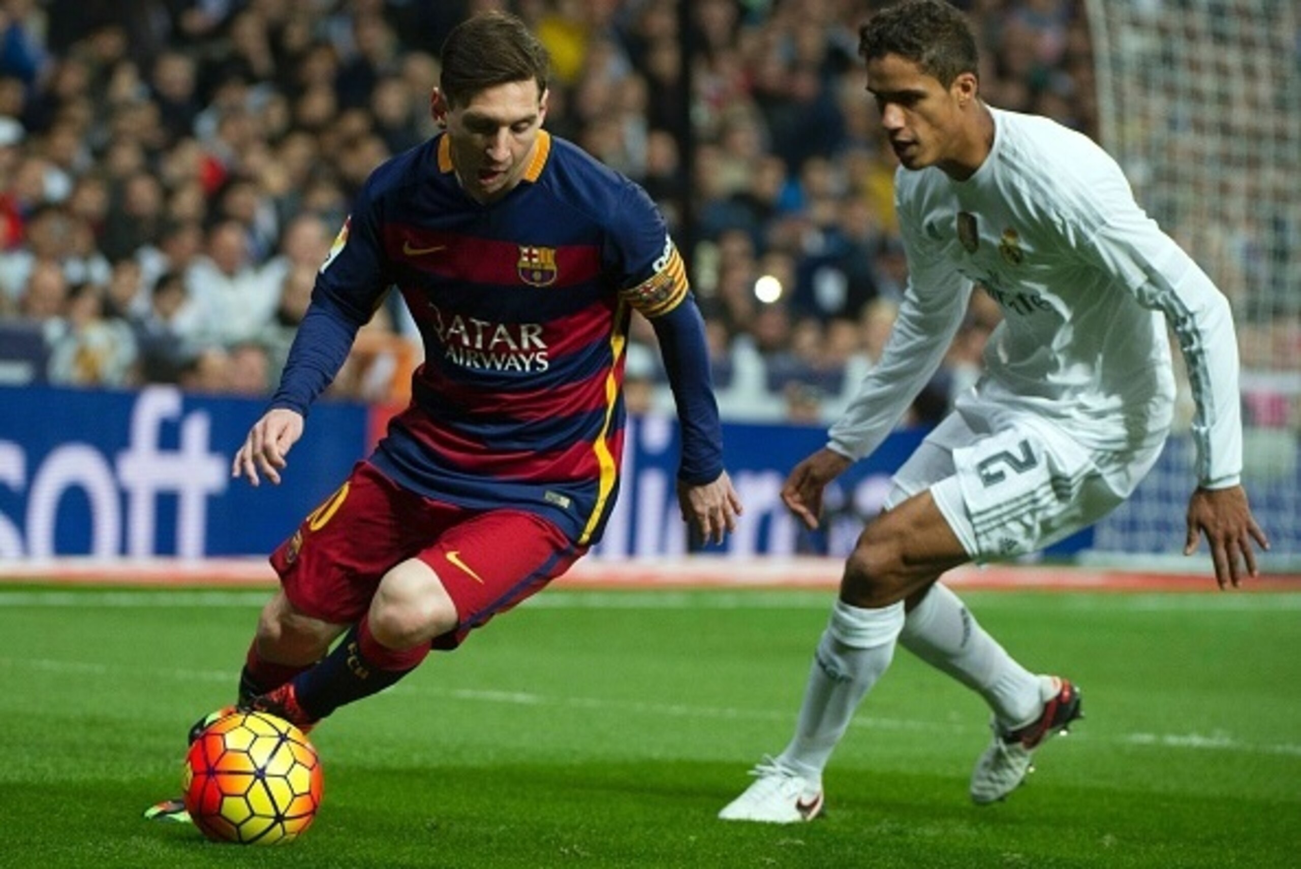 Barcelona's Argentinian forward Lionel Messi  (L) vies with Real Madrid's French defender Raphael Varane during the Spanish league 'Clasico' football match Real Madrid CF vs FC Barcelona at the Santiago Bernabeu stadium in Madrid on November 21, 2015.    
