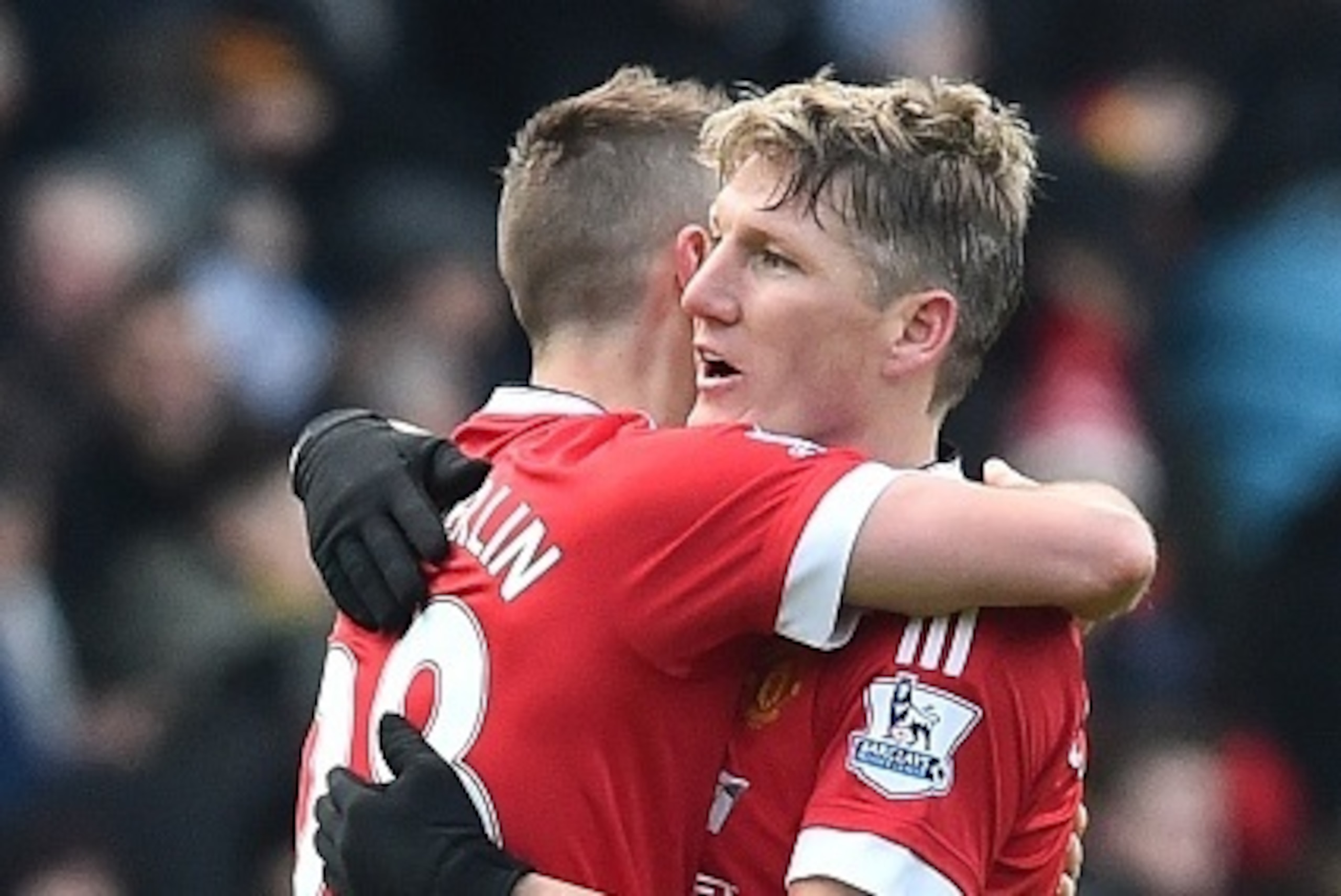 Manchester United's German midfielder Bastian Schweinsteiger (R) embraces Manchester United's French midfielder Morgan Schneiderlin (L) after the English Premier League football match between Watford and Manchester United at Vicarage Road Stadium in Watfo