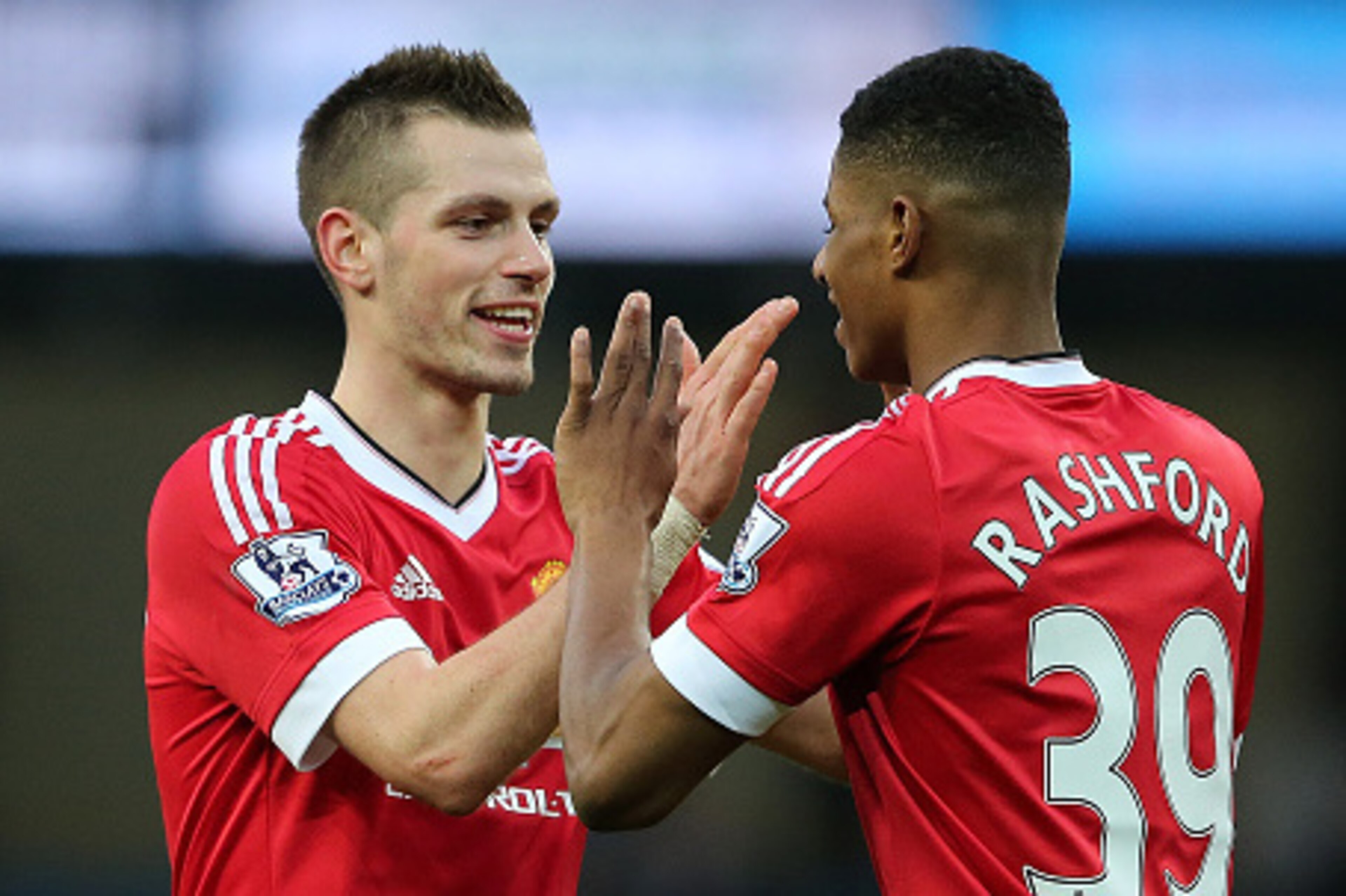 MANCHESTER, ENGLAND - MARCH 20:  Marcus Rashford of Manchester United celebrates with team-mate Morgan Schneiderlin (L) at the end of the Barclays Premier League match between Manchester City and Manchester United at the Etihad Stadium on March 20, 2016 i