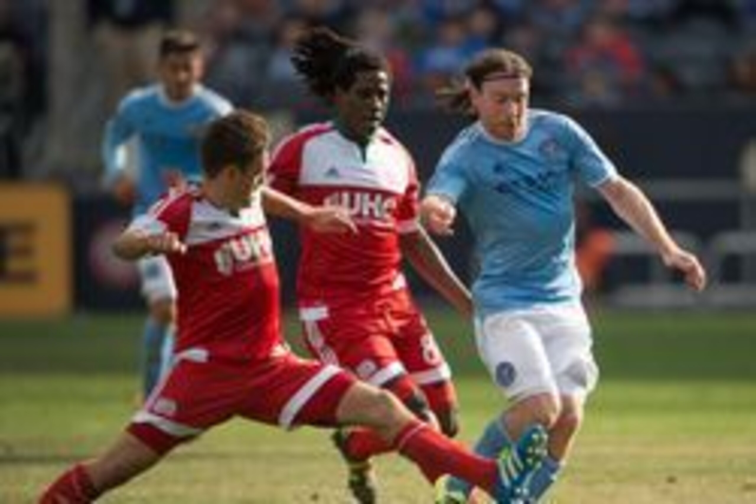 Mar 26, 2016; New York, NY, USA; New England Revolution midfielder Kelyn Rowe (11) tries to slide tackle New York City FC midfielder Thomas McNamara (15) in the second half  at Yankee Stadium. New England Revolution tie New York City FC 1-1. Mandatory Cre