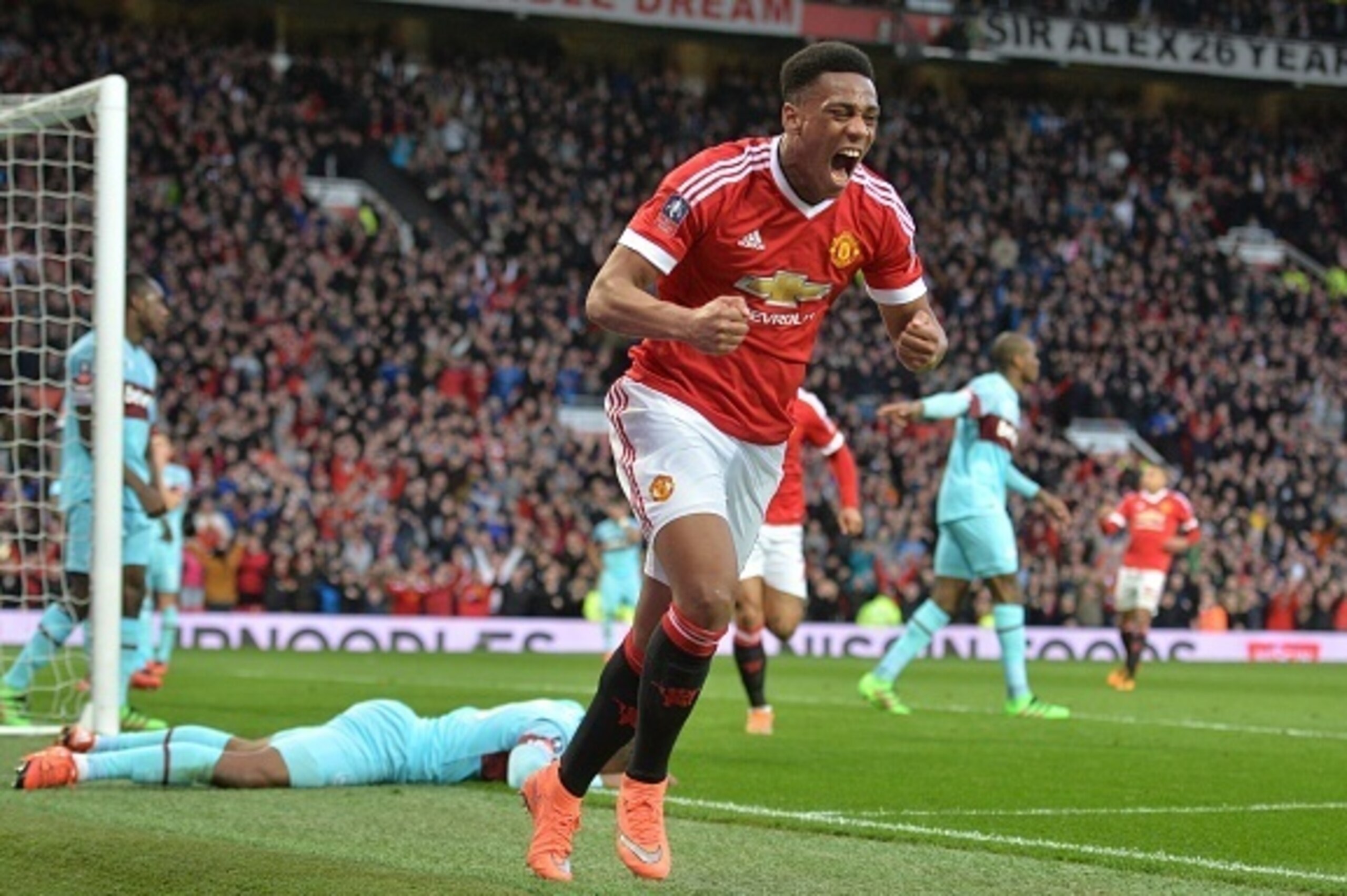 Manchester United's French striker Anthony Martial celebrates after scoring their first goal during the English FA Cup quarter final football match between Manchester United and West Ham United at Old Trafford in Manchester, north west England, on March 1