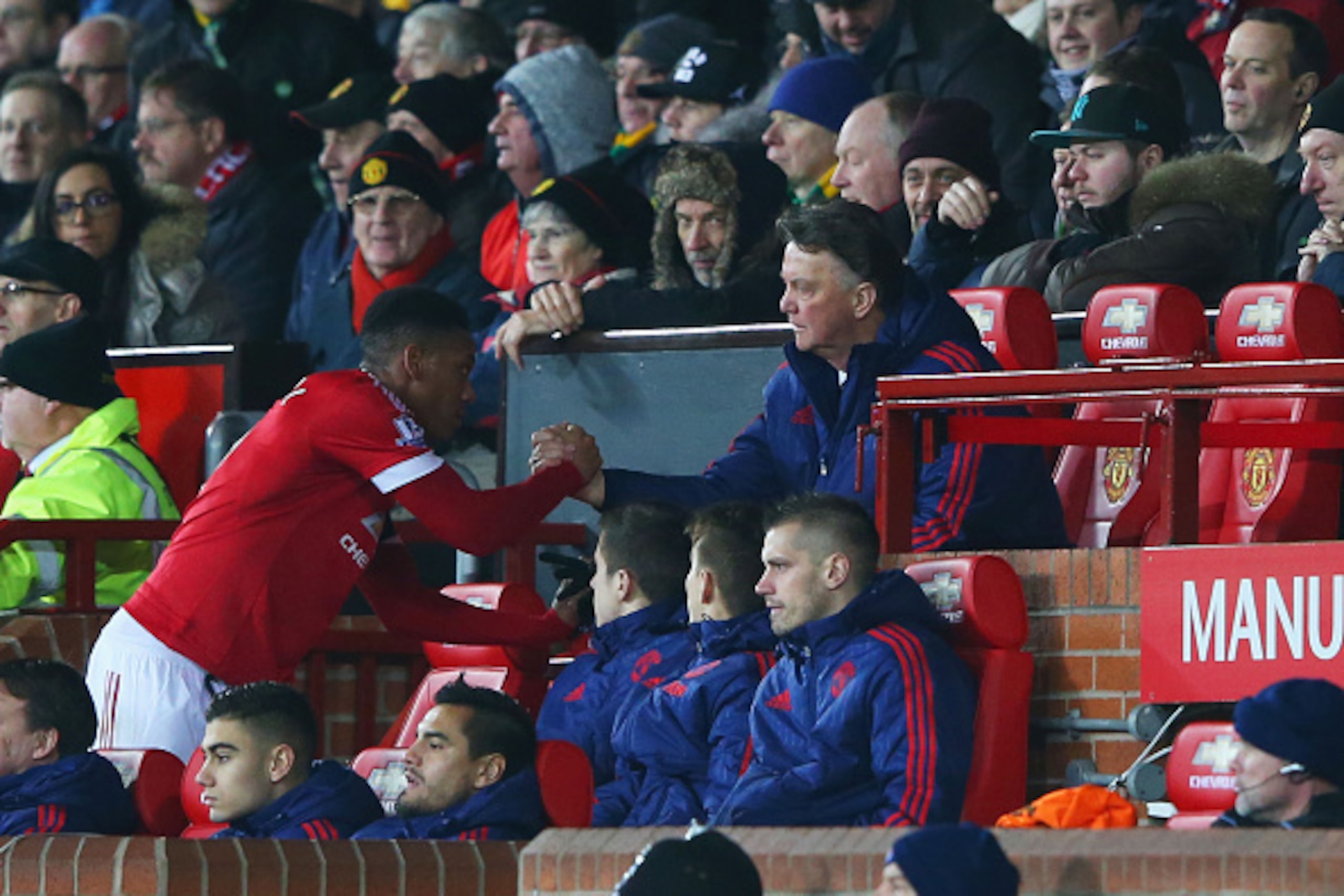 MANCHESTER, ENGLAND - FEBRUARY 02: Louis van Gaal Manager of Manchester United shakes hands with Anthony Martial on the bench during the Barclays Premier League match between Manchester United and Stoke City at Old Trafford on February 2, 2016 in Manchest