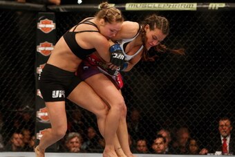 LAS VEGAS, NV - DECEMBER 28:  (L-R) Ronda Rousey attempts to take down Miesha Tate in their UFC women's bantamweight championship bout during the UFC 168 event at the MGM Grand Garden Arena on December 28, 2013 in Las Vegas, Nevada. (Photo by Josh Hedges/