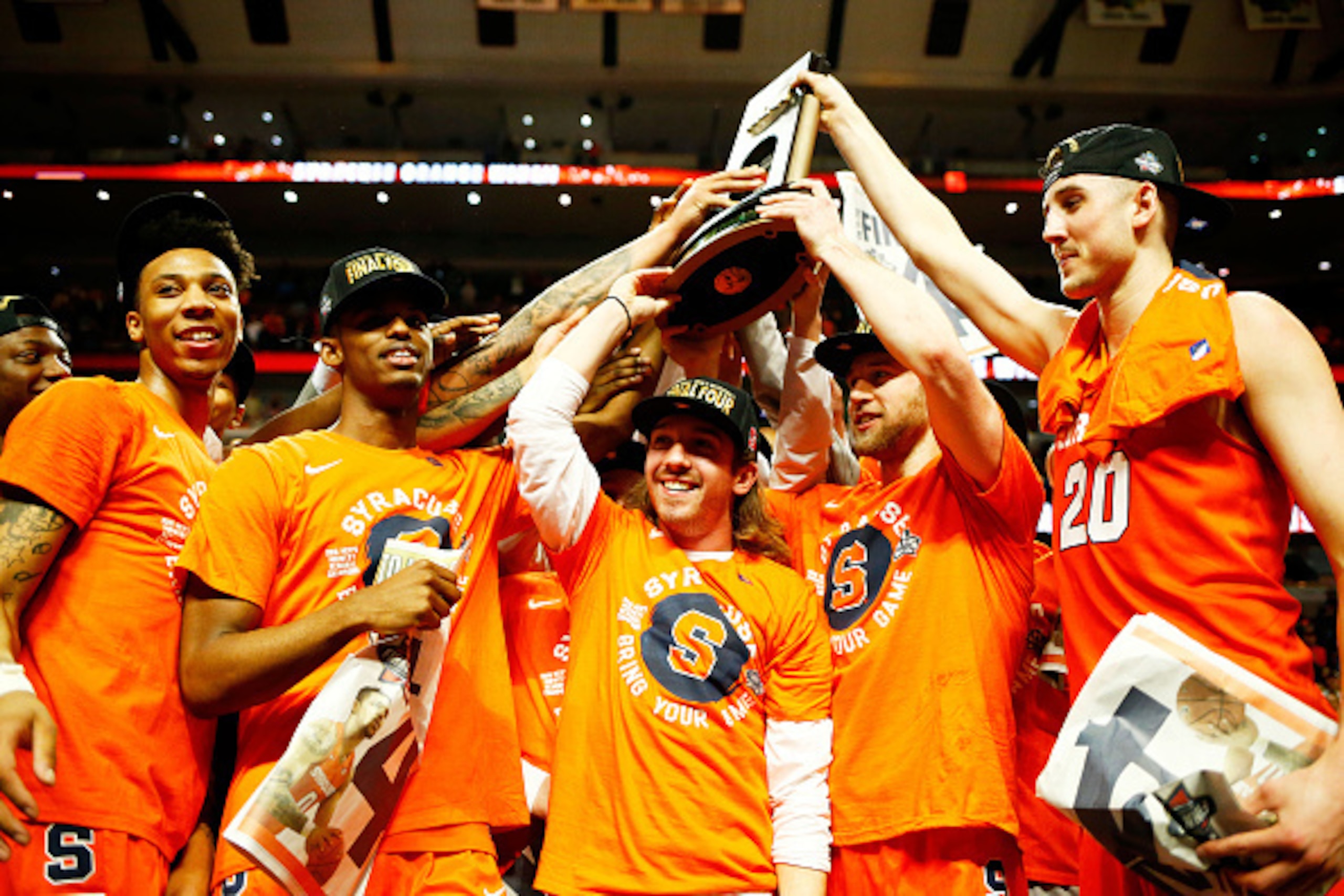 CHICAGO, IL - MARCH 27: The Syracuse Orange celebrate their 68 to 62 win over the Virginia Cavaliers with teammates during the 2016 NCAA Men's Basketball Tournament Midwest Regional Final at United Center on March 27, 2016 in Chicago, Illinois. (Photo b CHICAGO, IL - MARCH 27: The Syracuse Orange celebrate their 68 to 62 win over the Virginia Cavaliers with teammates during the 2016 NCAA Men's Basketball Tournament Midwest Regional Final at United Center on March 27, 2016 in Chicago, Illinois. (Photo b