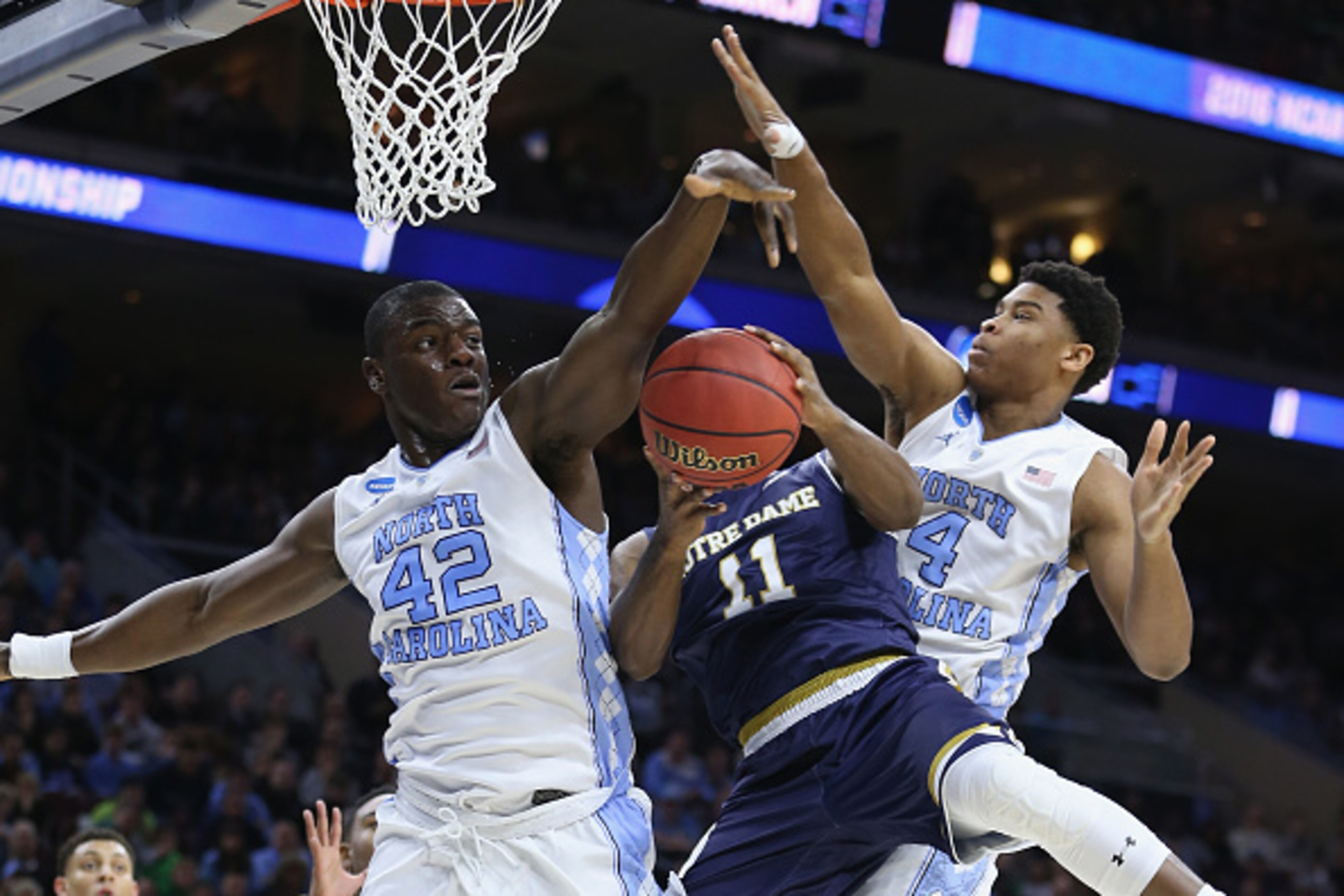 PHILADELPHIA, PA - MARCH 27:  Isaiah Hicks #4 and Joel James #42 of the North Carolina Tar Heels block a shot by Demetrius Jackson #11 of the Notre Dame Fighting Irish in the first half during the 2016 NCAA Men's Basketball Tournament East Regional Final 