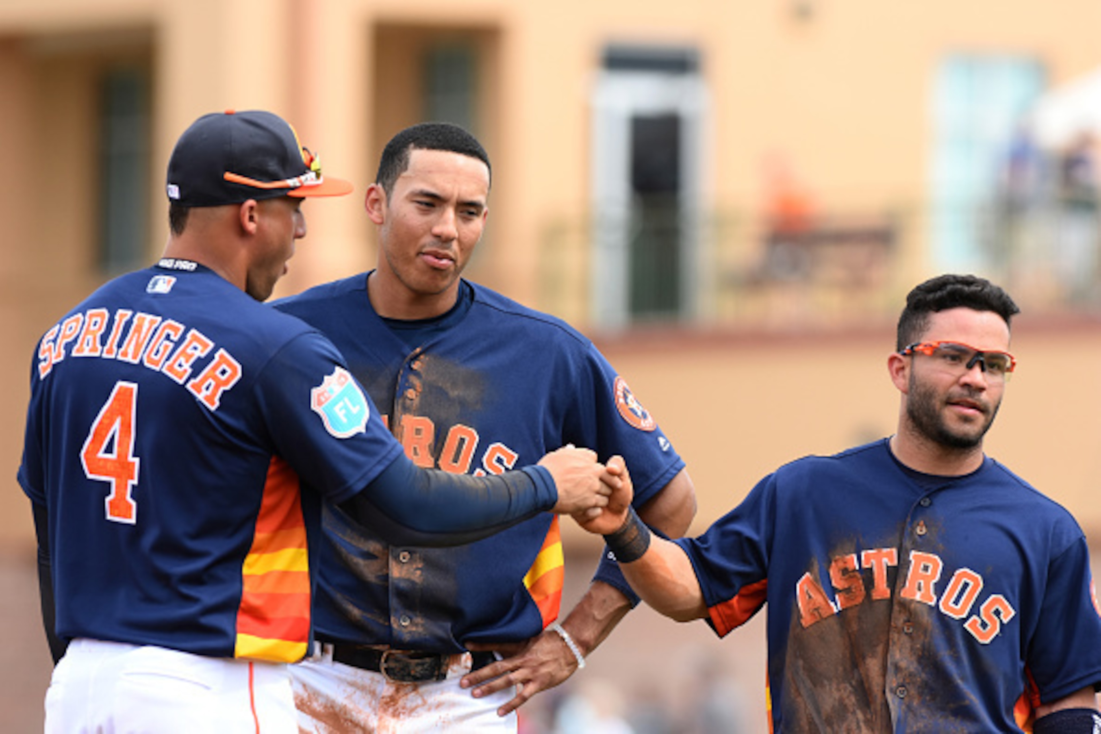 KISSIMMEE, FL - MARCH 11:  (L-R) George Springer #4, Carlos Correa #1 and Jose Altuve #27 of the Houston Astros stand together on the field during the Spring Training game against the Detroit Tigers at Osceola County Stadium on March 11, 2016 in Kissimmee