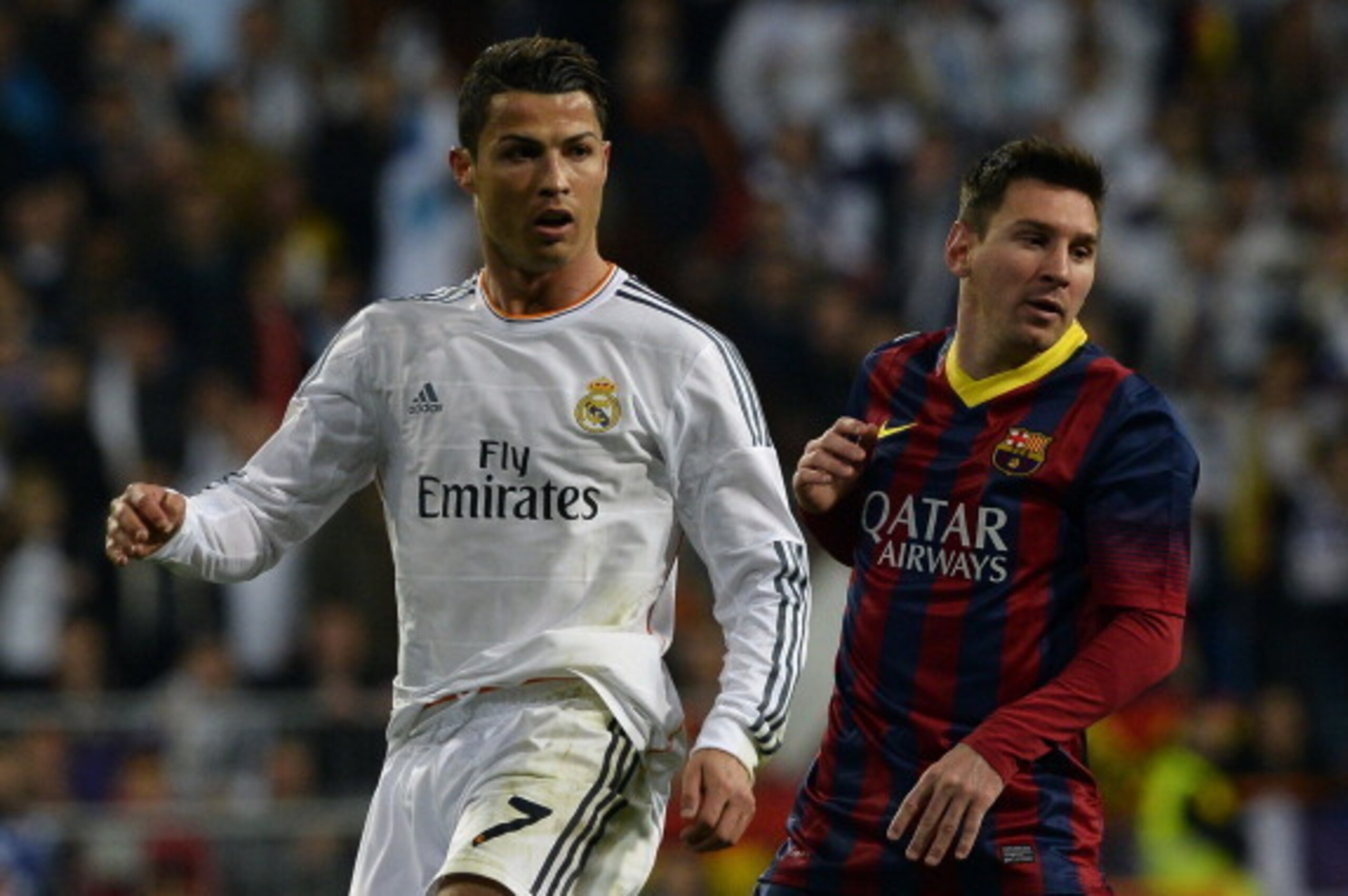 Real Madrid's Portuguese forward Cristiano Ronaldo (L) and Barcelona's Argentinian forward Lionel Messi look on during the Spanish league 'Clasico' football match Real Madrid CF vs FC Barcelona at the Santiago Bernabeu stadium in Madrid on March 23, 2014.