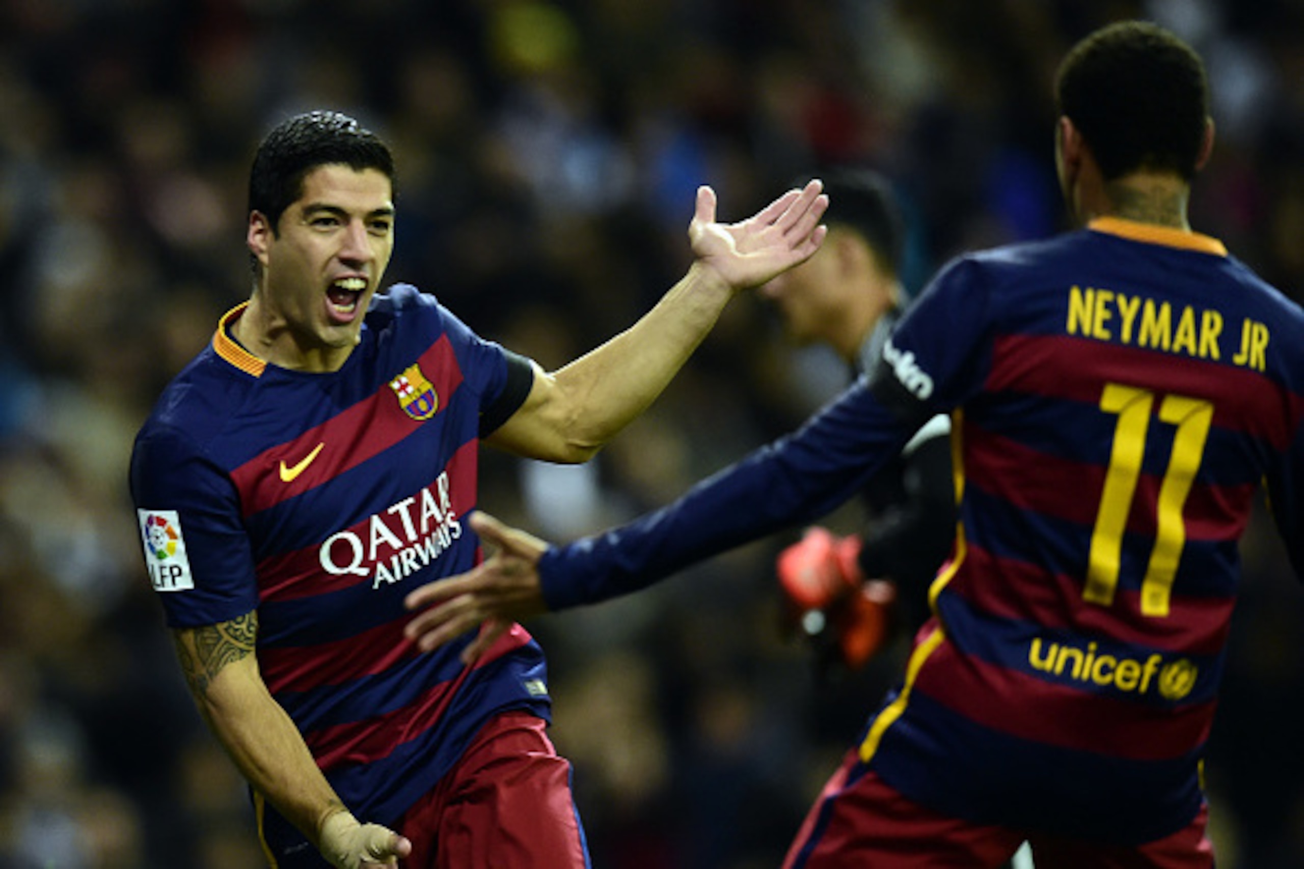 Barcelona's Uruguayan forward Luis Suarez (L) celebrates a goal with Barcelona's Brazilian forward Neymar during the Spanish league 'Clasico' football match Real Madrid CF vs FC Barcelona at the Santiago Bernabeu stadium in Madrid on November 21, 2015.  /