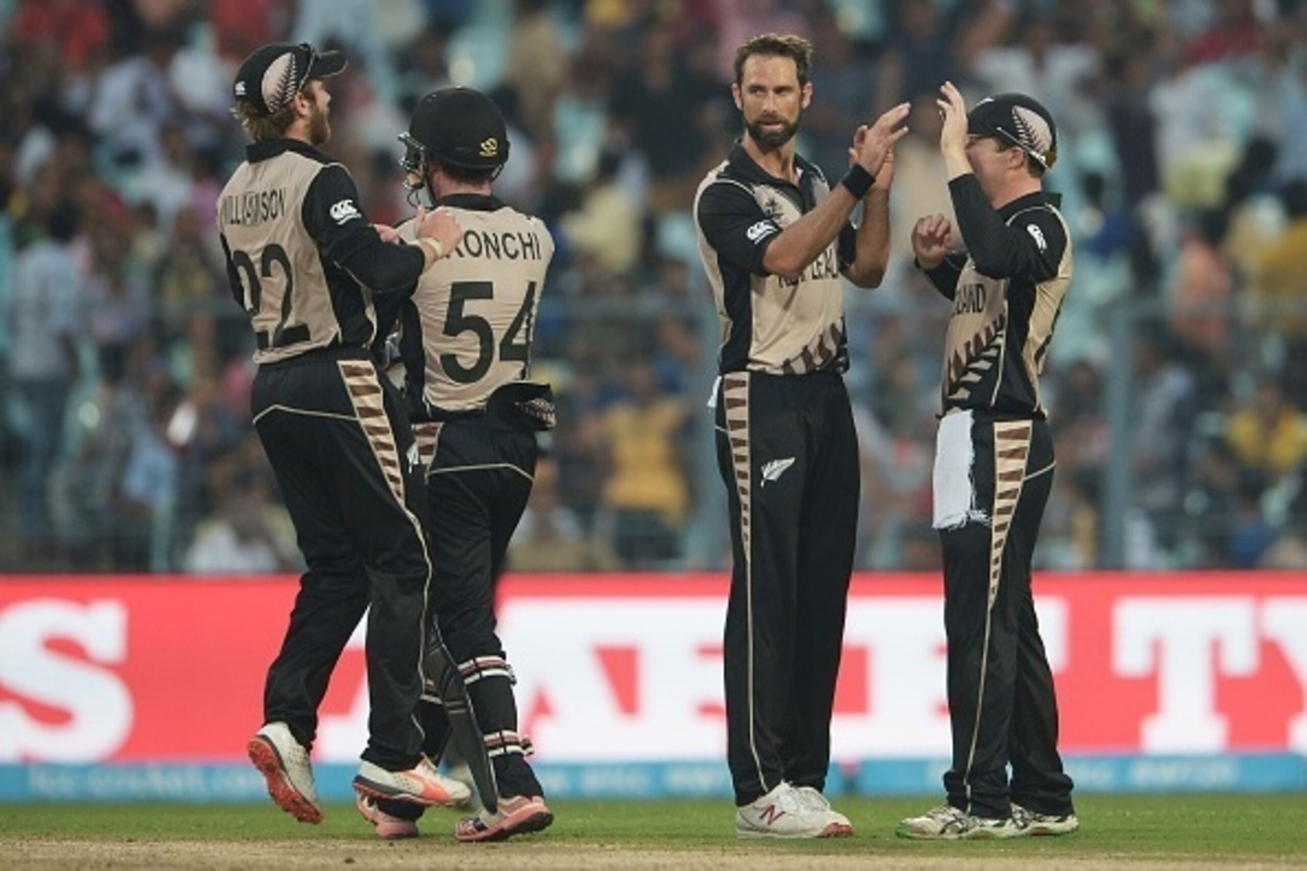 New Zealand's Grant Elliott(C)celebrates with teammates after the dismissal of Bangladesh's captain Mashrafe Bin Mortaza during the World T20 cricket tournament match between Bangladesh and New Zealand at The Eden Gardens Cricket Stadium in Kolkata on Mar