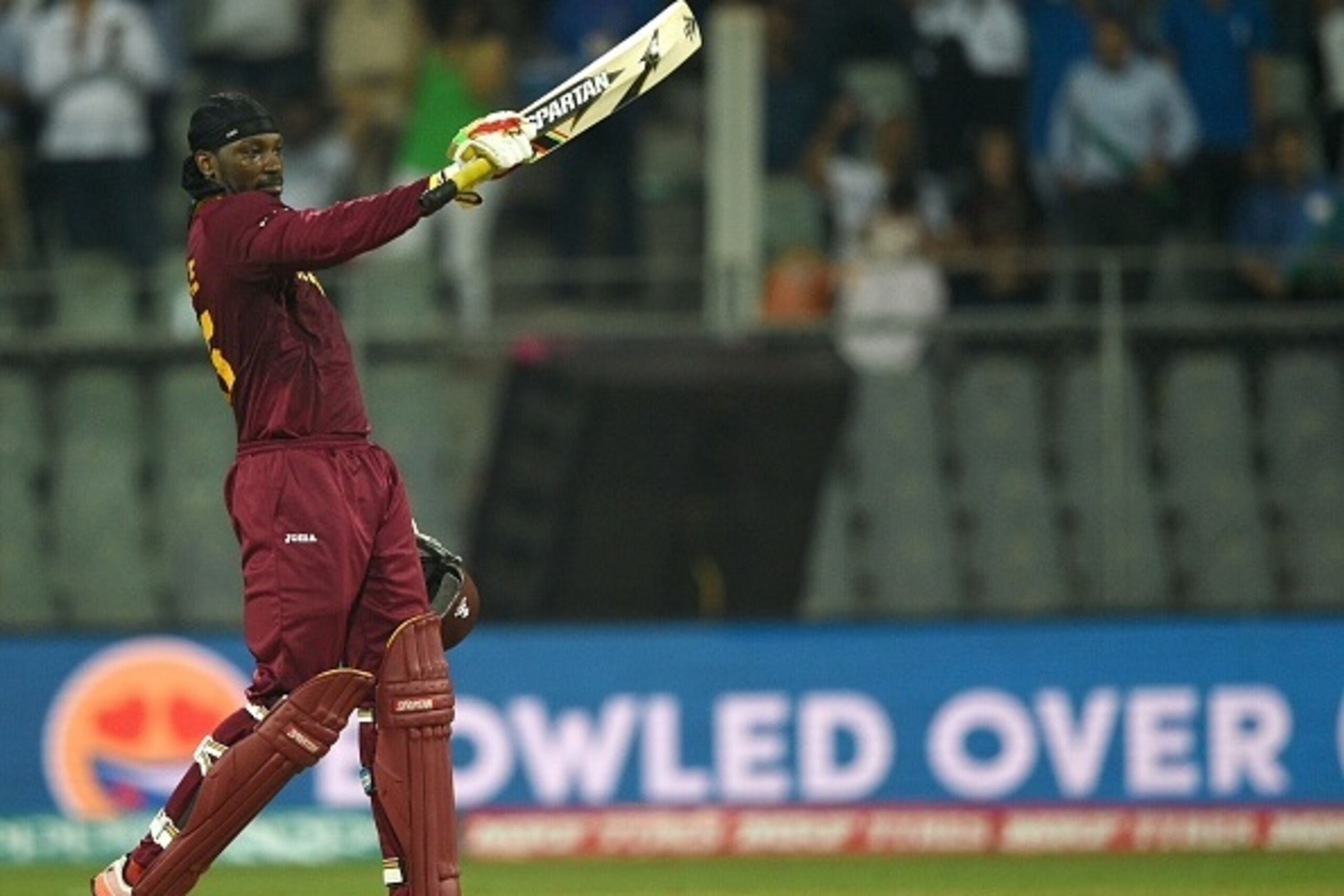 West Indies's Chris Gayle celebrates after scoring his century (100runs) during the World T20 cricket tournament match between England and West Indies at The Wankhede Cricket Stadium in Mumbai on March 16, 2016.
 / AFP / INDRANIL MUKHERJEE        (Photo c