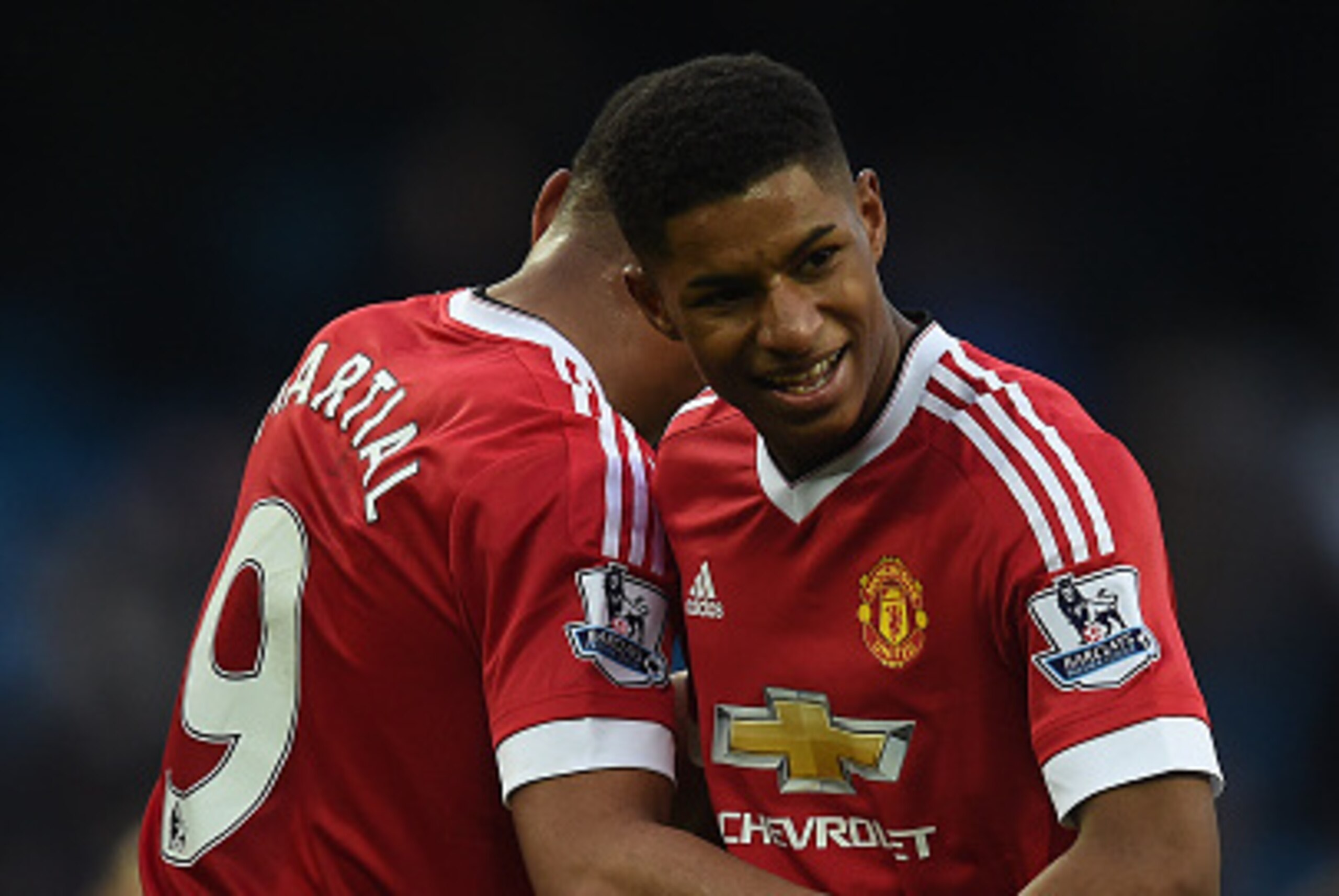 Manchester United's English striker Marcus Rashford (R) hugs Manchester United's French striker Anthony Martial following the English Premier League football match between Manchester City and Manchester United at the Etihad Stadium in Manchester, north we