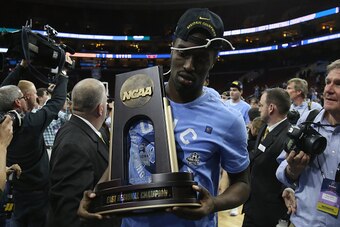 PHILADELPHIA, PA - MARCH 27:  Theo Pinson #1 of the North Carolina Tar Heels celebrates with the trophy after defeating the Notre Dame Fighting Irish with a score of 74 to 88 in the 2016 NCAA Men's Basketball Tournament East Regional Final at Wells Fargo 