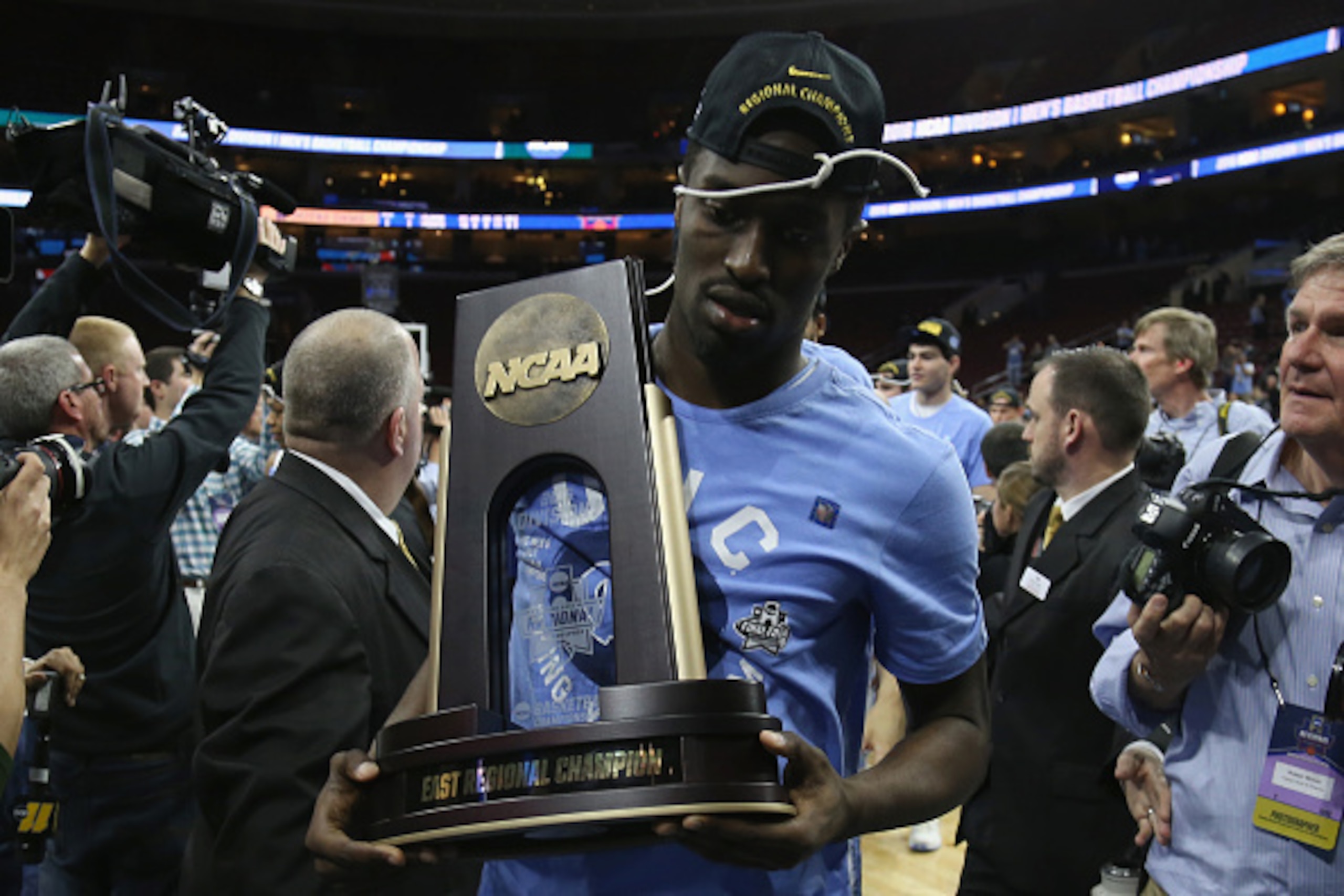 PHILADELPHIA, PA - MARCH 27:  Theo Pinson #1 of the North Carolina Tar Heels celebrates with the trophy after defeating the Notre Dame Fighting Irish with a score of 74 to 88 in the 2016 NCAA Men's Basketball Tournament East Regional Final at Wells Fargo 