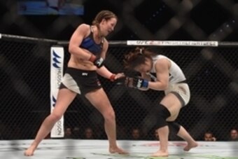 Mar 20, 2015; Brisbane, Australia; Leslie Smith (red gloves) competes against Rin Nakai (blue gloves) during UFC Fight Night at Brisbane Entertainment Centre. Mandatory Credit: Matt Roberts-USA TODAY Sports