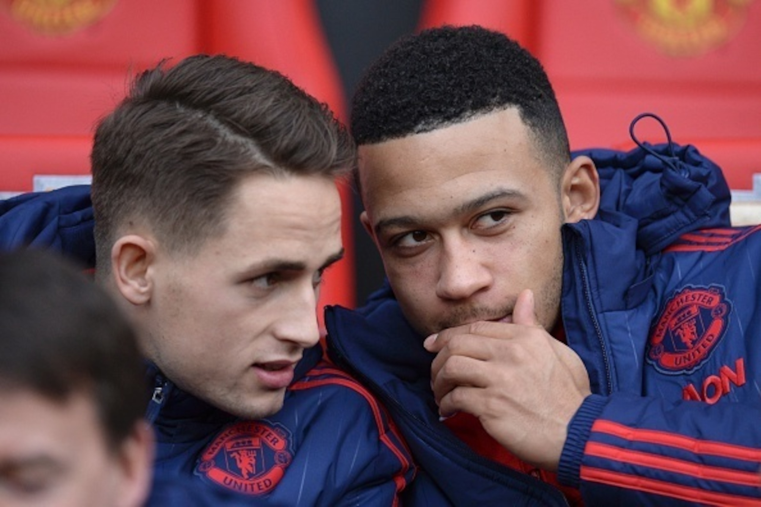 Manchester United's Dutch midfielder Memphis Depay (R) talks with Manchester United's Belgian midfielder Adnan Januzaj (L) on the substitutes bench ahead of the English Premier League football match between Manchester United and Southampton at Old Traffor