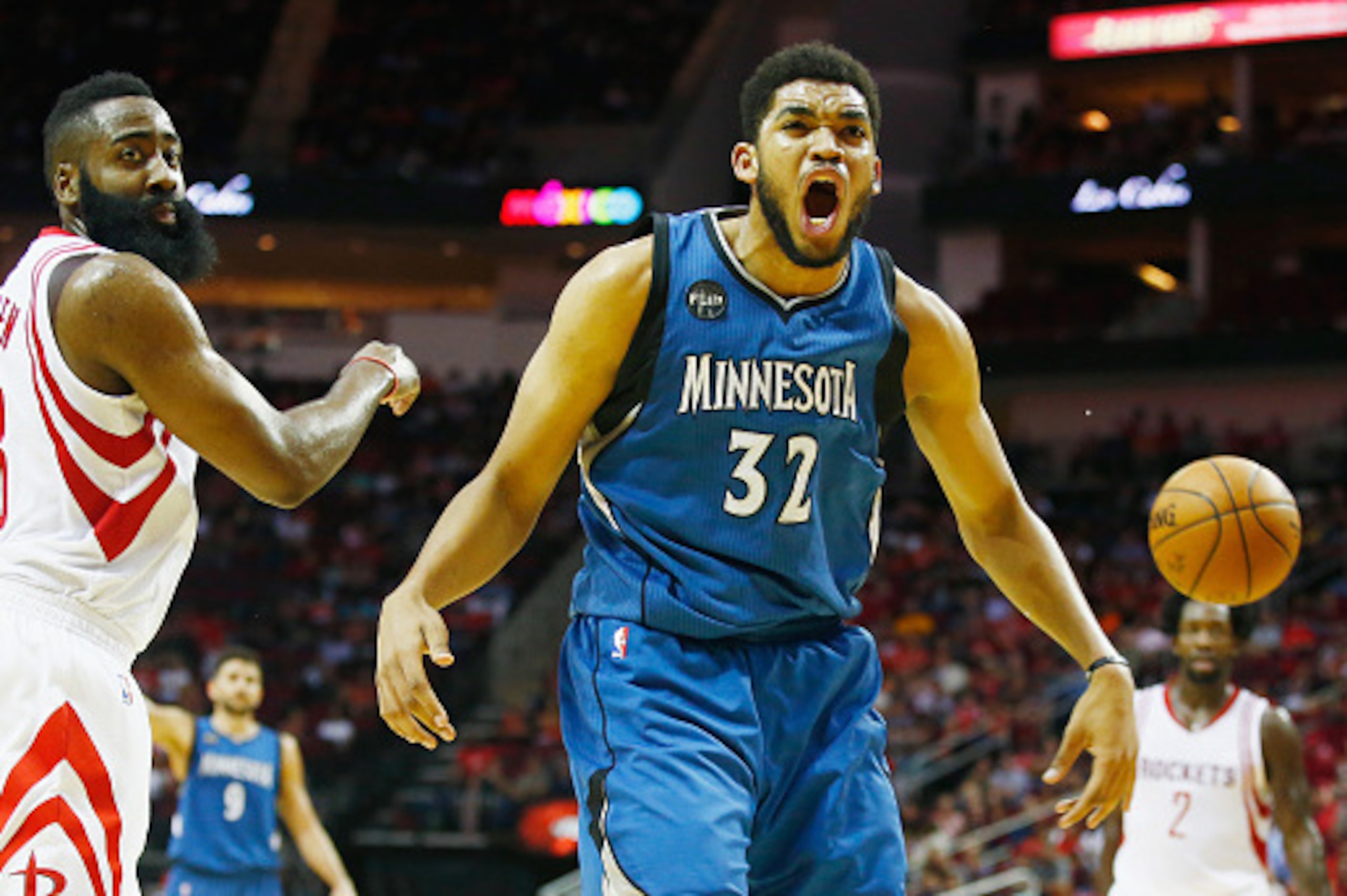 HOUSTON, TX - MARCH 18:  Karl-Anthony Towns #32 of the Minnesota Timberwolves reacts to a call in front of James Harden #13 of the Houston Rockets on the court during their game at the Toyota Center on March 18, 2016 in Houston, Texas.  NOTE TO USER: User