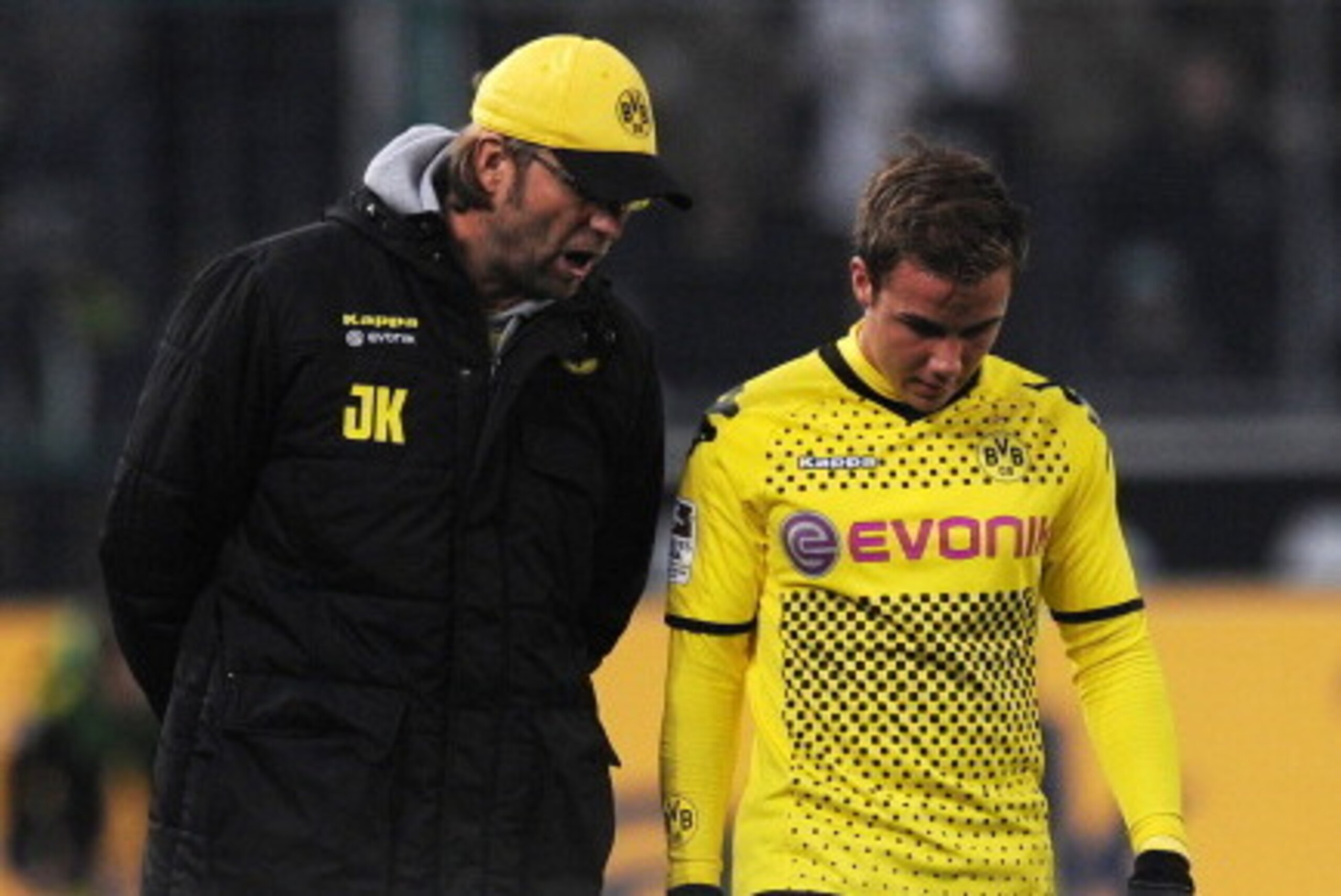 Dortmund's head coach Juergen Klopp (L) talks to Dortmund's midfielder Mario Goetze during the German first division Bundesliga football match Borussia Moenchengladbach vs Borussia Dortmund in Moenchengladbach, western Germany on December 3, 2011. The mat