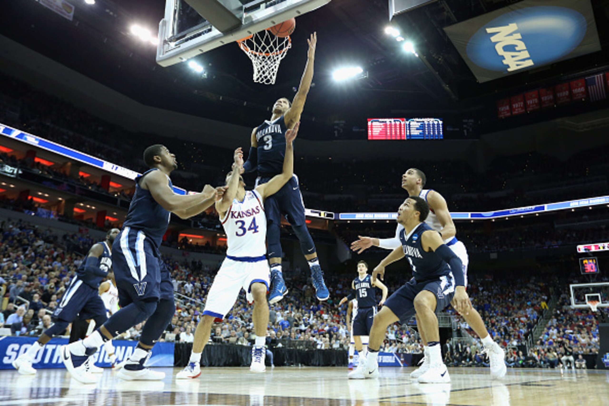 LOUISVILLE, KY - MARCH 26:  Josh Hart #3 of the Villanova Wildcats shoots the ball in the first half against Perry Ellis #34 of the Kansas Jayhawks during the 2016 NCAA Men's Basketball Tournament South Regional at KFC YUM! Center on March 26, 2016 in Lou