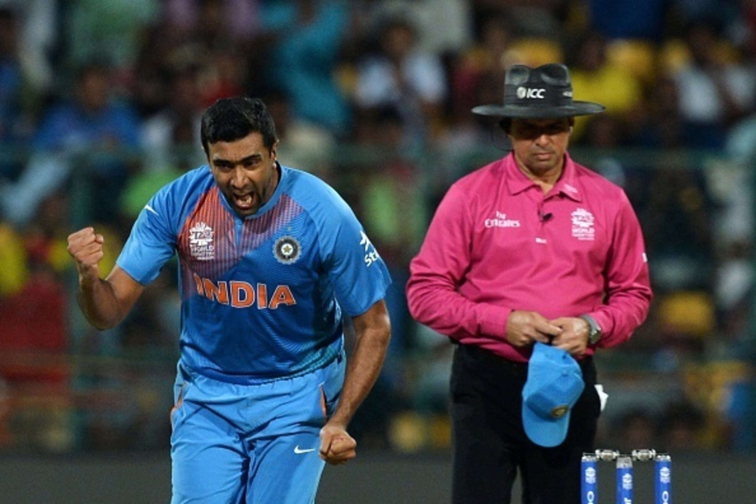 Indian bowler Ravichandran Ashwin(L)celebrates the dismissal of Bangladesh batsman Shakib Al Hasan during the World T20 cricket tournament match between India and Bangladesh at The Chinnaswamy Stadium in Bangalore on March 23, 2016. 
Bangladesh is chasing