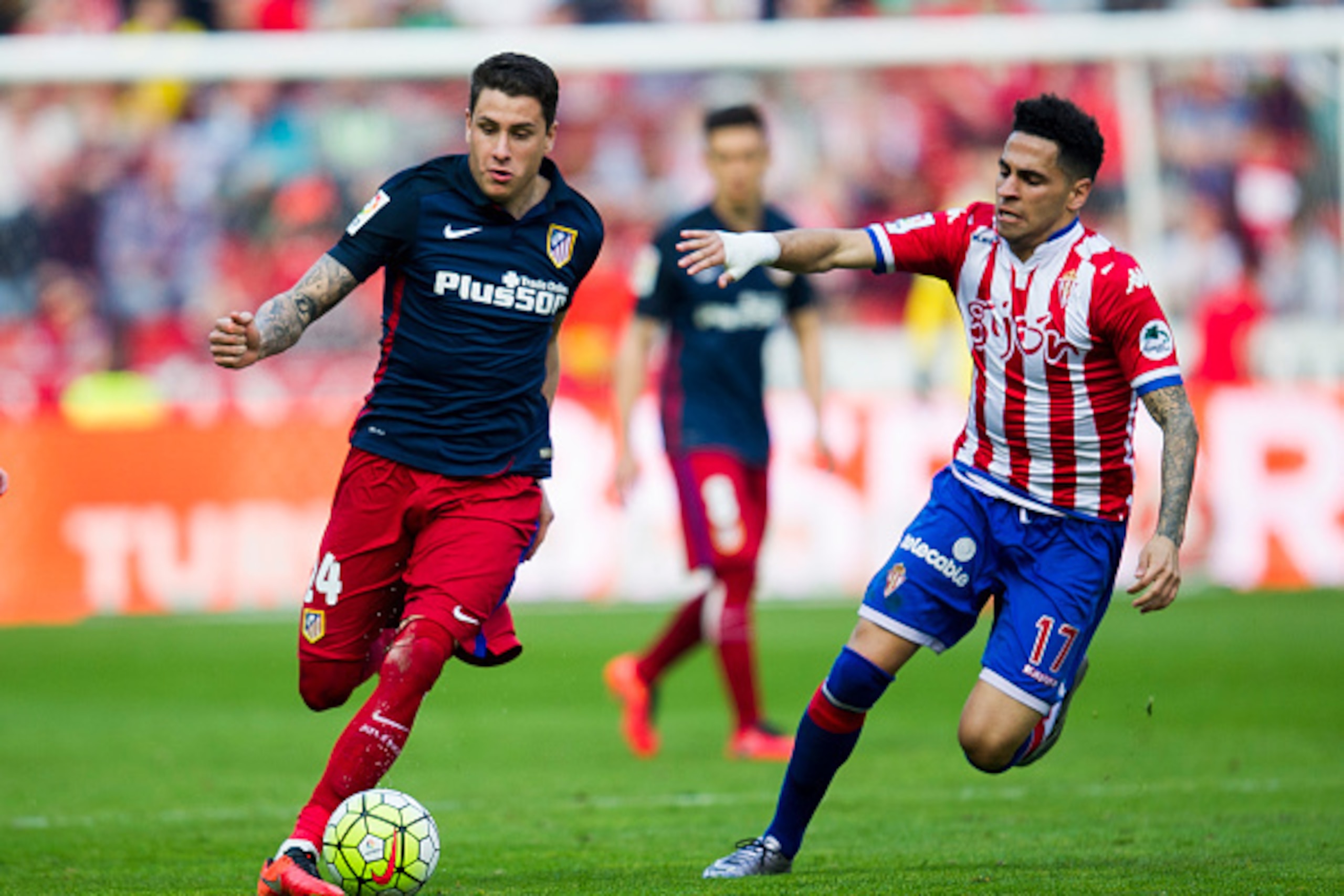 GIJON, SPAIN - MARCH 19: Jose Maria Gimenez of Club Atletico de Madrid duels for the ball with Mascarell of Real Sporting de Gijon during the La Liga match between Real Sporting de Gijon and Club Atletico de Madrid at Estadio El Molinon on March 19, 2016 