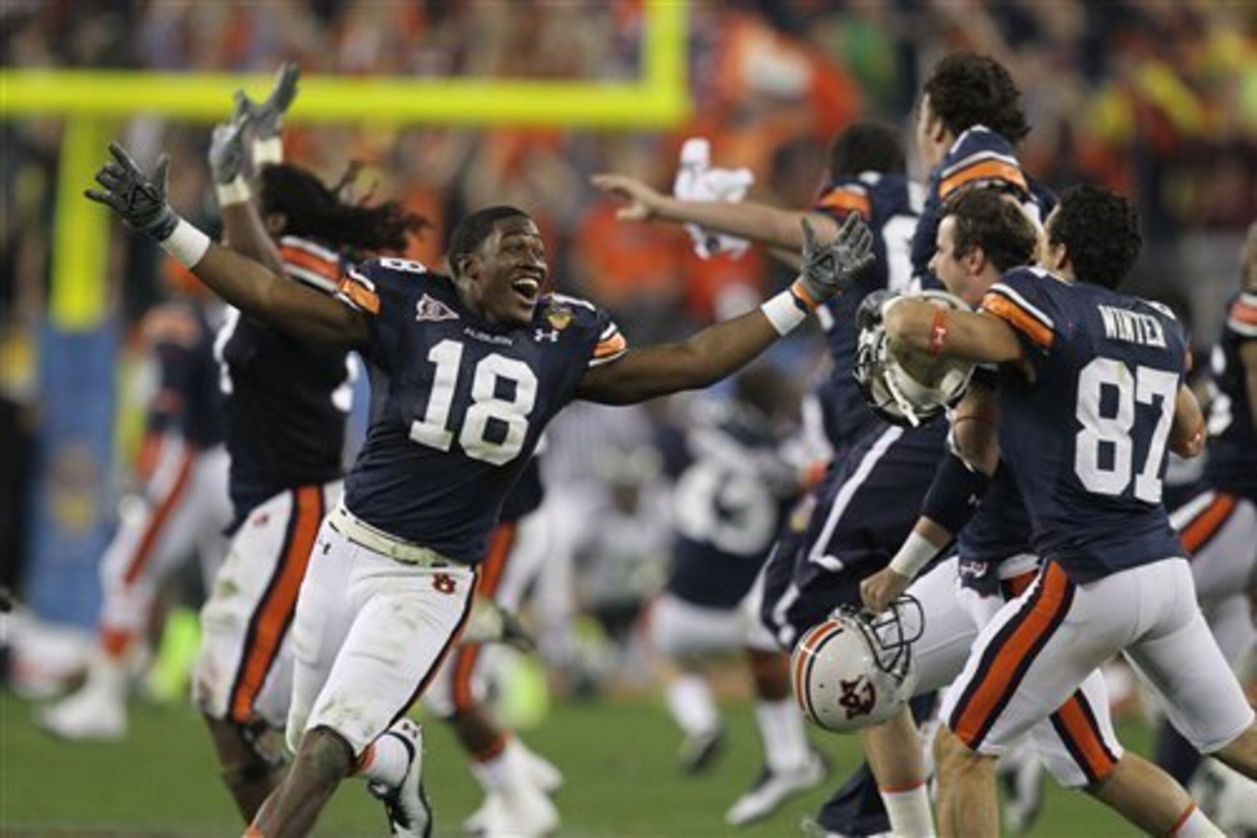 Auburn WR coach Kodi Burns (left) at 2011 BCS National Championship Game Auburn WR coach Kodi Burns (left) at 2011 BCS National Championship Game