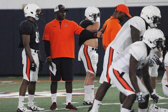 Auburn WR coach Kodi Burns (center)