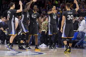 PHILADELPHIA, PA - JANUARY 30: Klay Thompson #11, Draymond Green #23, Harrison Barnes #40, Shaun Livingston #34 and Stephen Curry #30 high five one another in the game against the Philadelphia 76ers on January 30, 2016 at the Wells Fargo Center in Philade