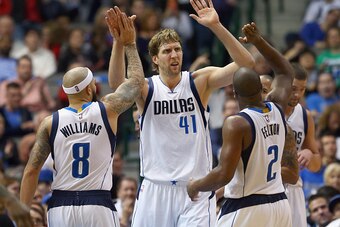 DALLAS, TX - DECEMBER 14:  Dirk Nowitzki #41 of the Dallas Mavericks celebrates with Deron Williams #8 of the Dallas Mavericks and Raymond Felton #2 of the Dallas Mavericks in the second half against the Phoenix Suns at American Airlines Center on Decembe