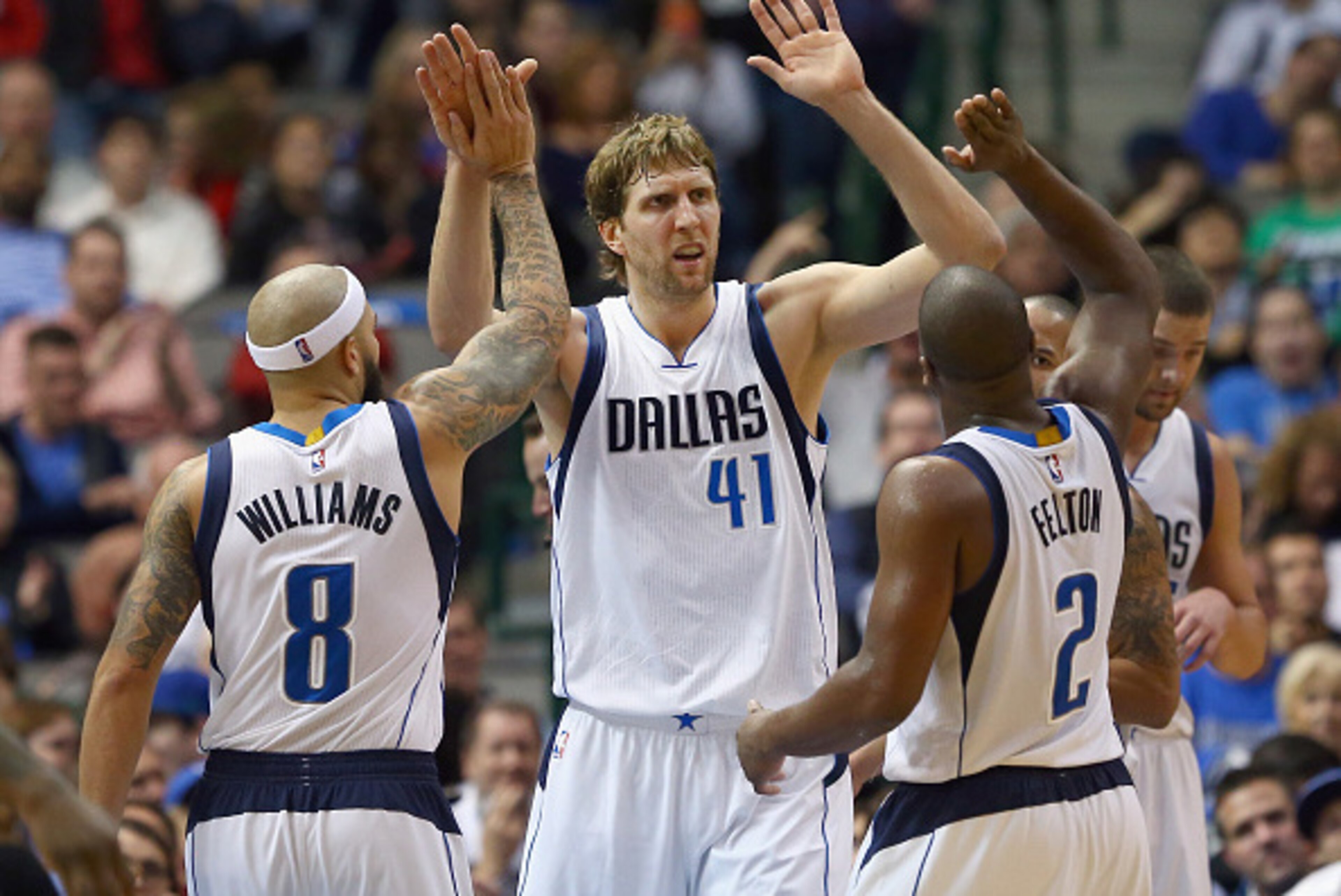 DALLAS, TX - DECEMBER 14:  Dirk Nowitzki #41 of the Dallas Mavericks celebrates with Deron Williams #8 of the Dallas Mavericks and Raymond Felton #2 of the Dallas Mavericks in the second half against the Phoenix Suns at American Airlines Center on Decembe