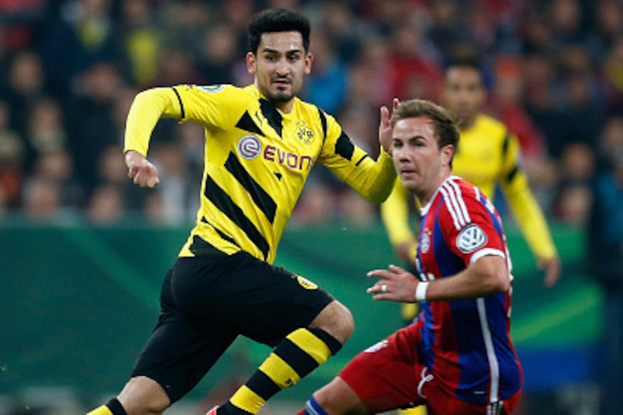 MUNICH, GERMANY - APRIL 28: Mario Goetze (R) of Muenchen battles for the ball with Ilkay Guendogan of Dortmund during the DFB Cup semi final match between FC Bayern Muenchen and Borussia Dortmund at Allianz Arena on April 28, 2015 in Munich, Germany. (P MUNICH, GERMANY - APRIL 28: Mario Goetze (R) of Muenchen battles for the ball with Ilkay Guendogan of Dortmund during the DFB Cup semi final match between FC Bayern Muenchen and Borussia Dortmund at Allianz Arena on April 28, 2015 in Munich, Germany. (P
