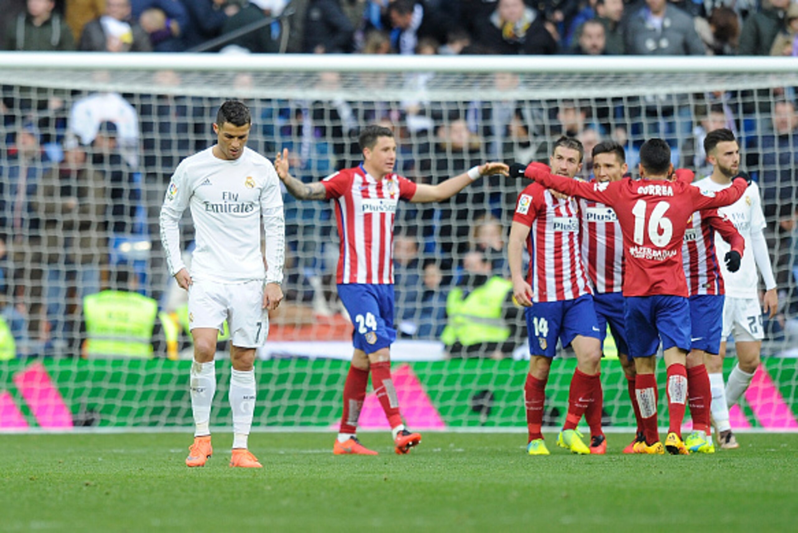 MADRID, SPAIN - FEBRUARY 27:  Cristiano Ronaldo of Real Madrid walks away from celebrating Atletico Madrid players after Atletico beat Real 1-0 in the La Liga match between Real Madrid CF and Club Atletico de Madrid at Estadio Santiago Bernabeu on Februar