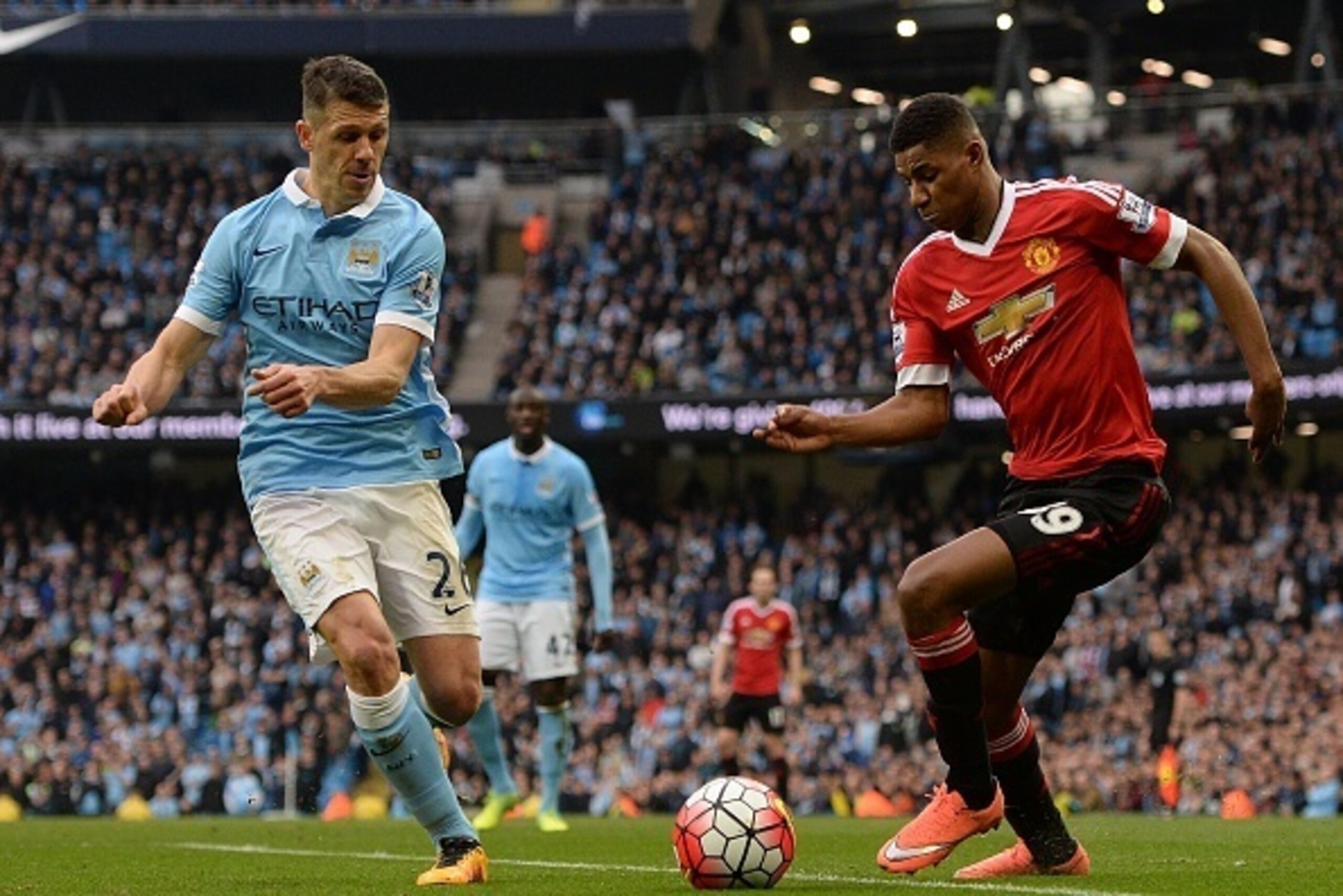 Manchester City's Argentinian defender Martin Demichelis (L) vies with Manchester United's English striker Marcus Rashford during the English Premier League football match between Manchester City and Manchester United at the Etihad Stadium in Manchester, 